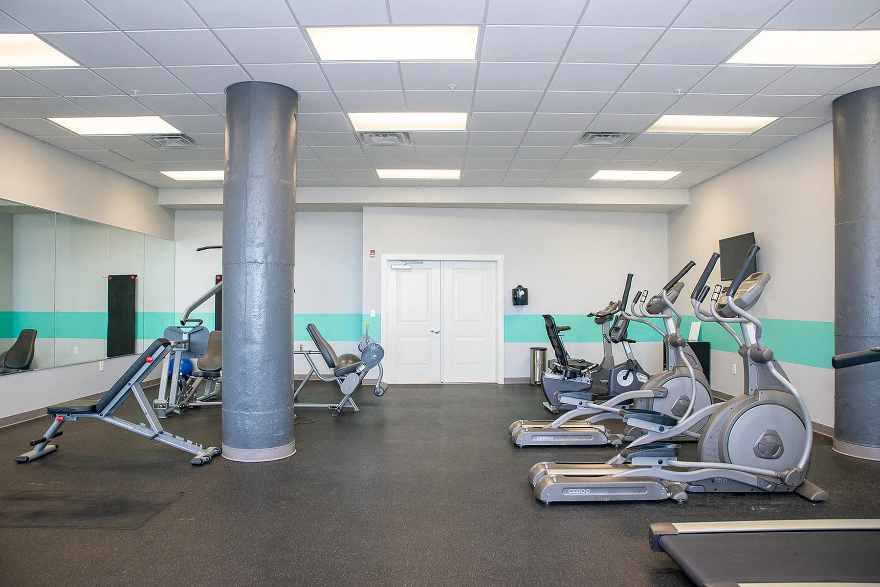 Bright, modern fitness center featuring state-of-the-art exercise equipment and ample workout space.