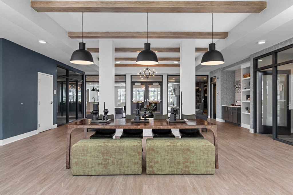 Spacious and modern communal lobby with elegant wooden accents, cozy seating, and abundant natural light.