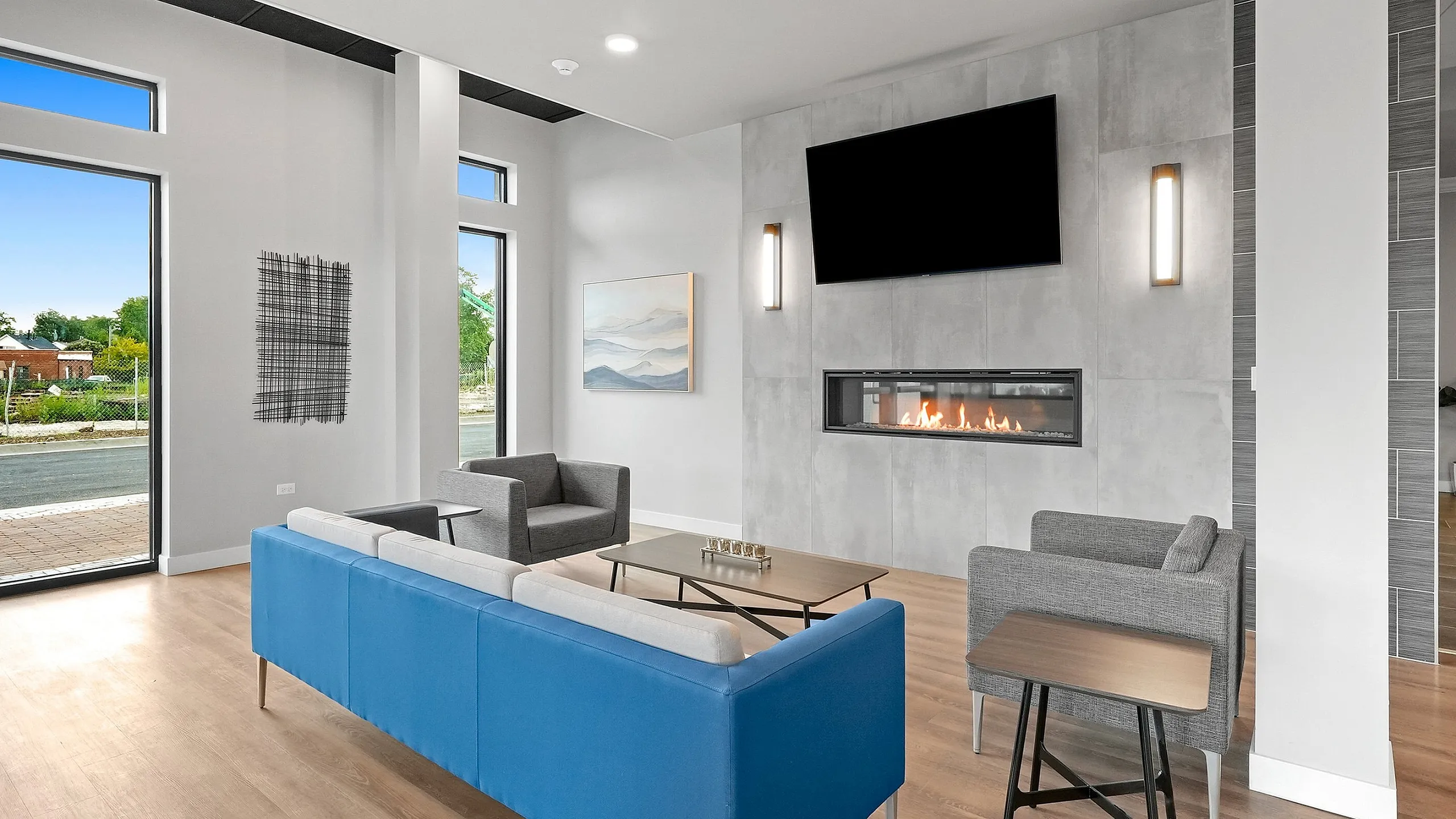 Elegant living room with modern fireplace, plush seating, and large windows offering abundant natural light.