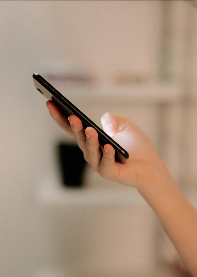 Close-up of a person using a smartphone, illustrating modern connectivity and digital lifestyle.