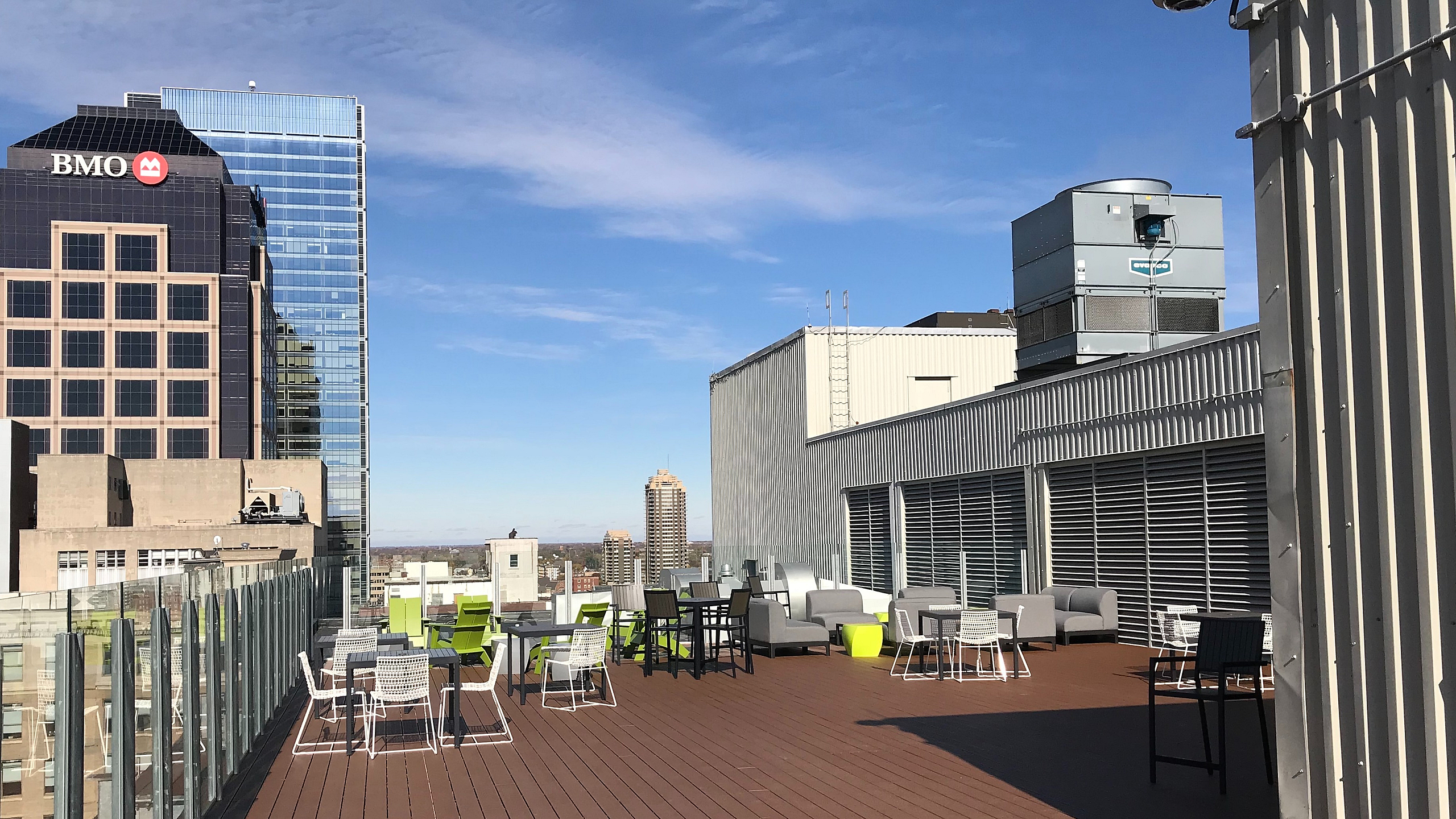 Modern rooftop terrace with stylish seating and panoramic city views, perfect for relaxation and entertainment.