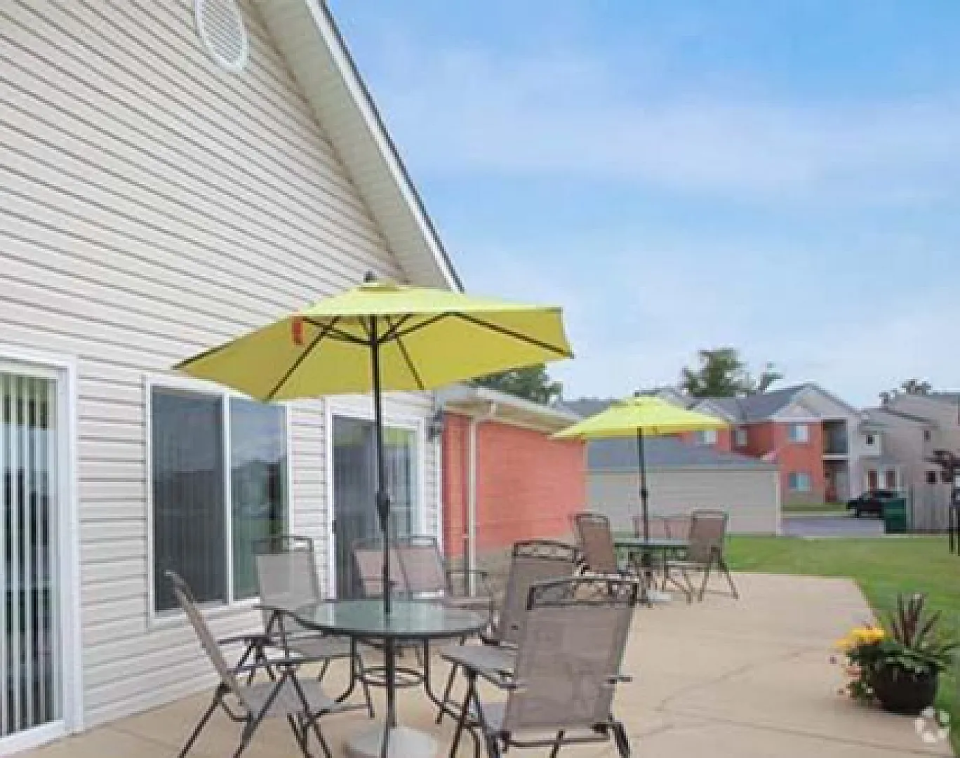 Inviting outdoor patio with stylish furniture and vibrant umbrellas, perfect for relaxation and gatherings.