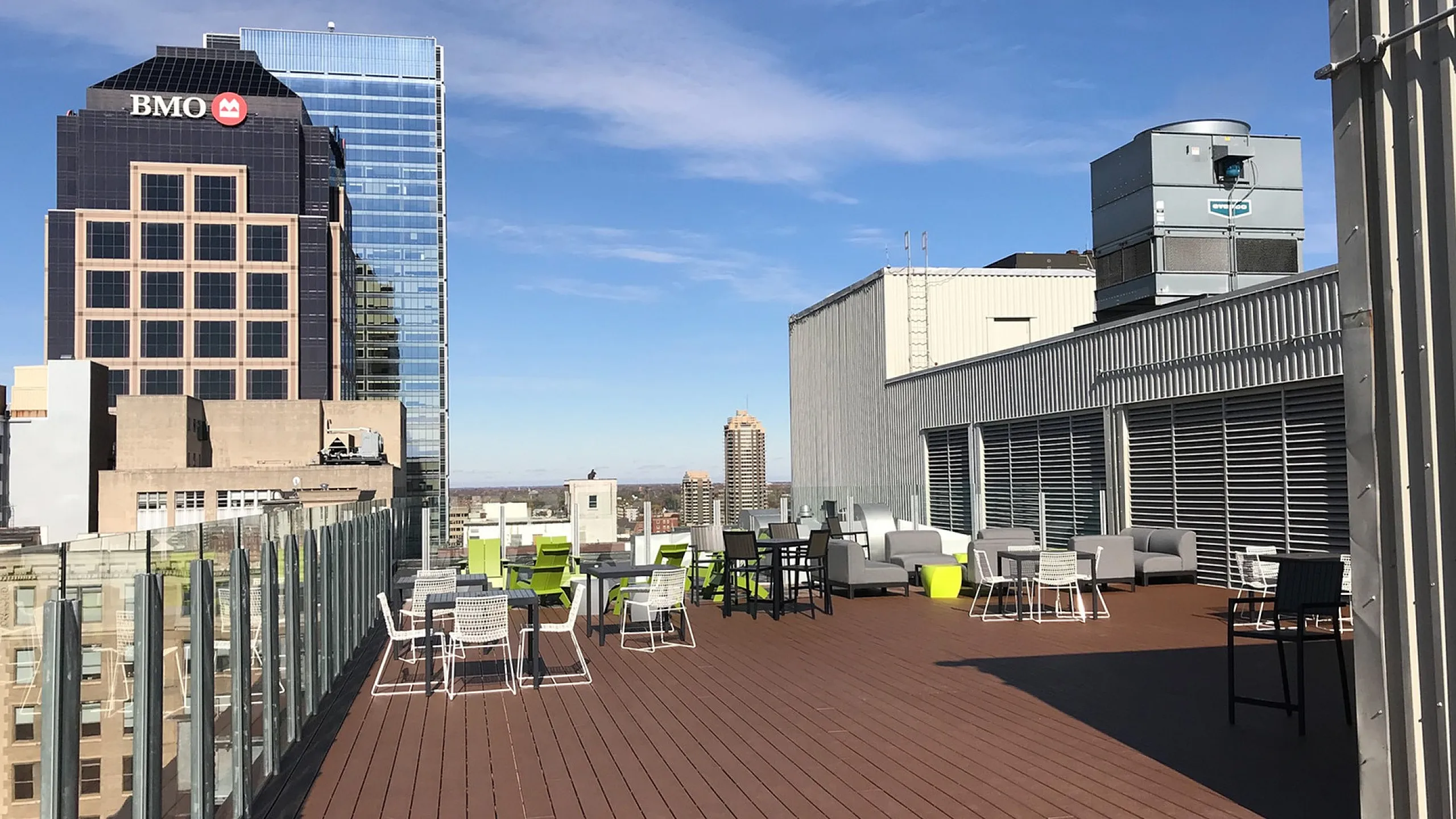Expansive rooftop terrace with modern seating offers stunning city views and ample space for relaxation.