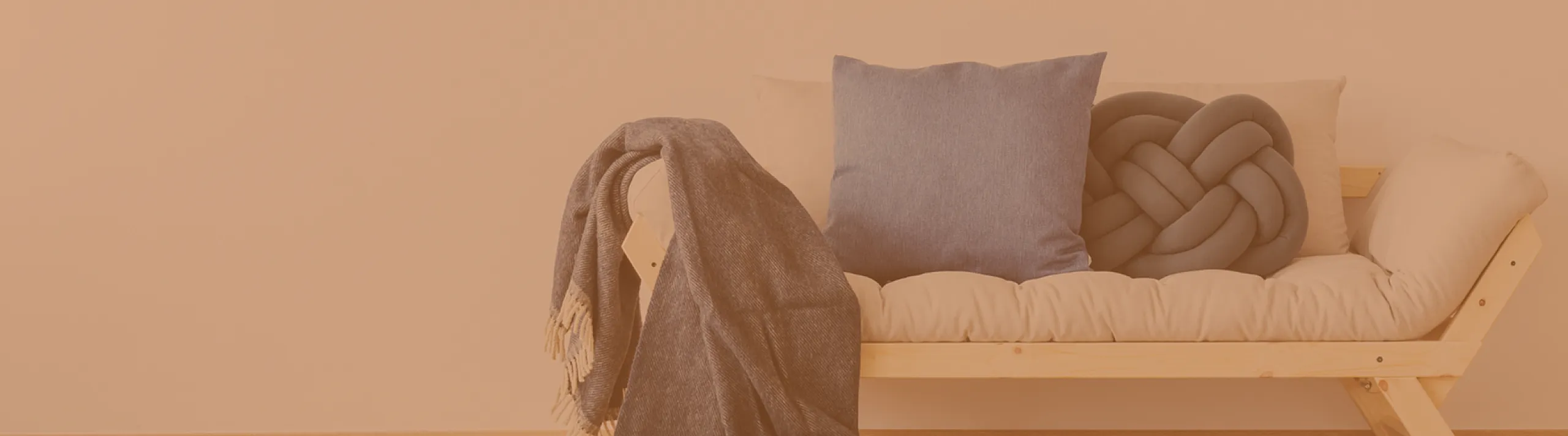 Cozy living space featuring a modern wooden bench with plush cushions and stylish pillows.