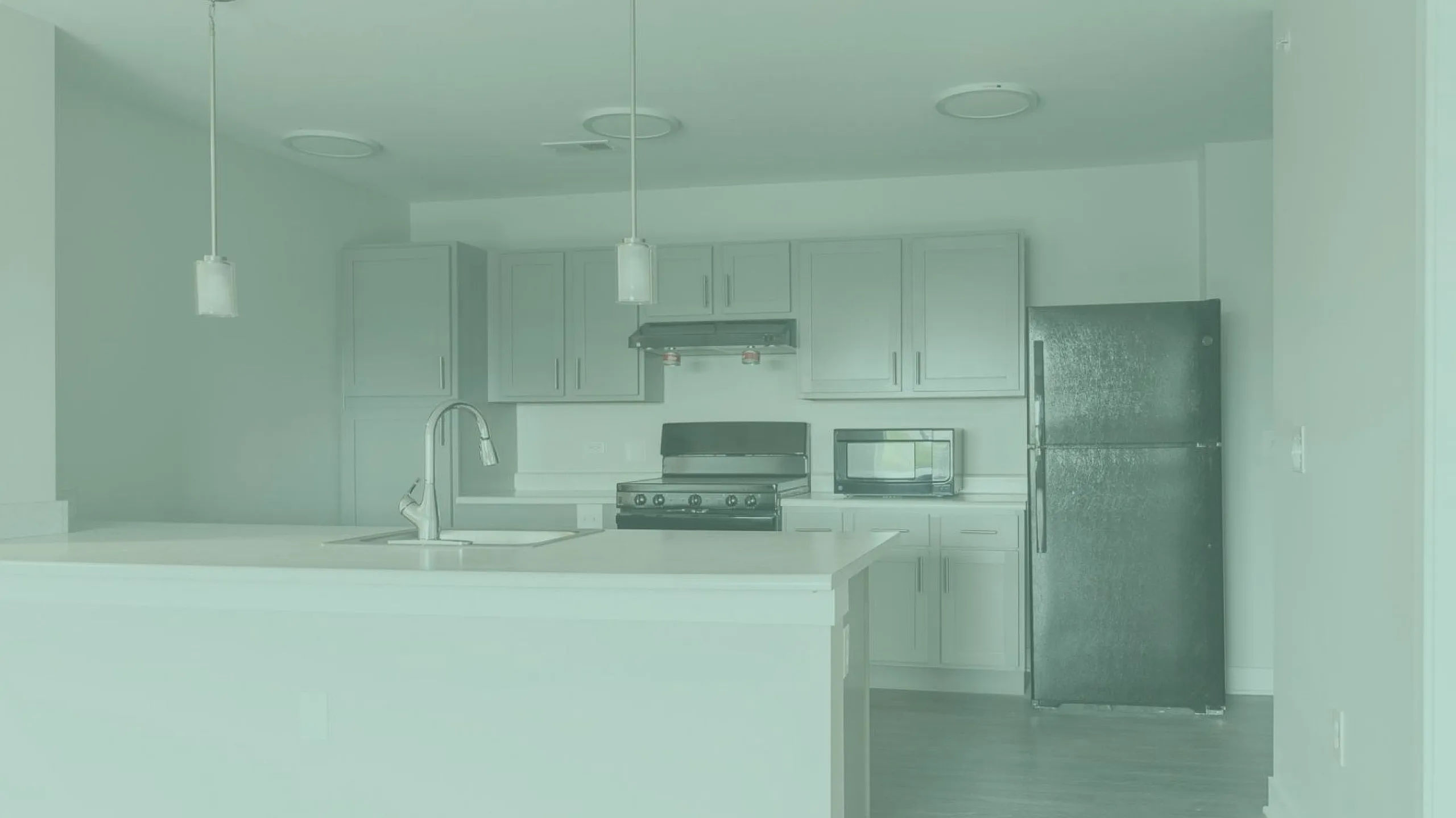 Modern kitchen design with sleek cabinetry, elegant pendant lighting, and stainless steel appliances.