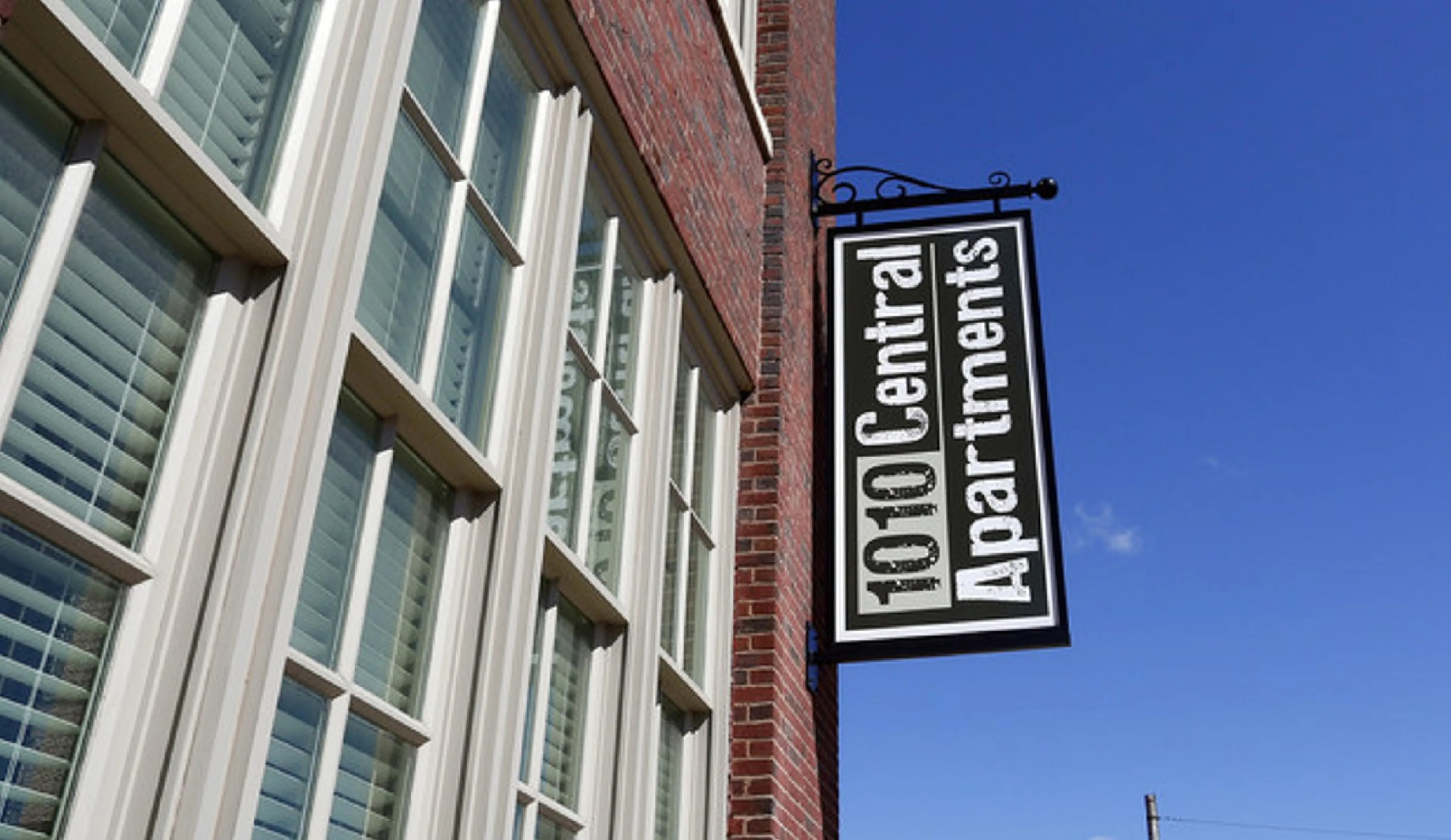 Elegant facade of 1010 Central Apartments with classic brick design and sunlit windows, perfect for urban living.