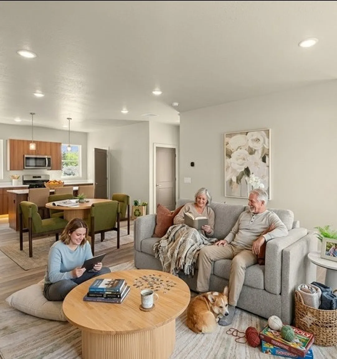 Cozy living room with a warm ambiance, modern kitchen in the background, and a family enjoying quality time with their dog.