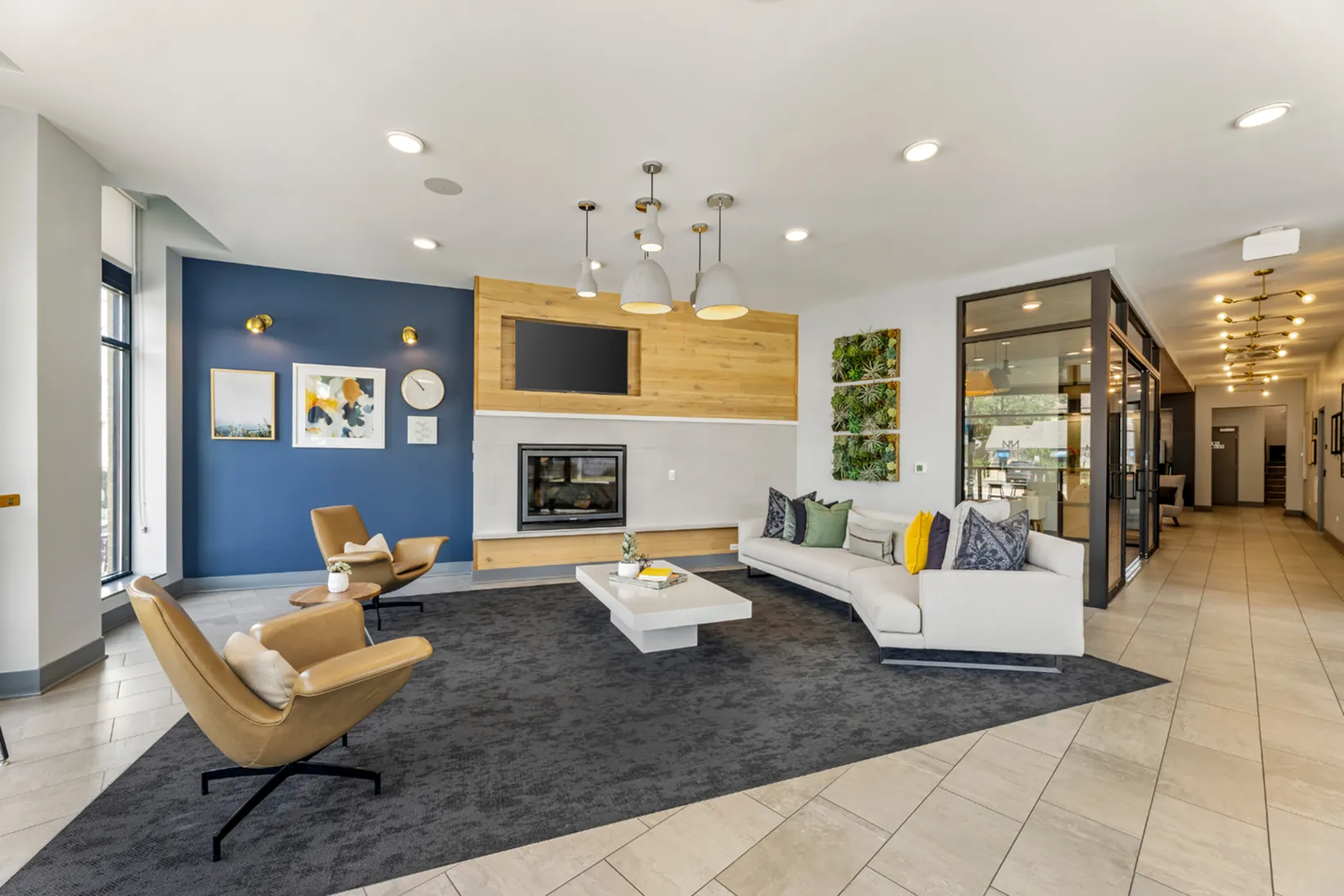 Inviting modern lobby with stylish seating, elegant lighting, and a cozy fireplace, creating a warm and welcoming atmosphere.