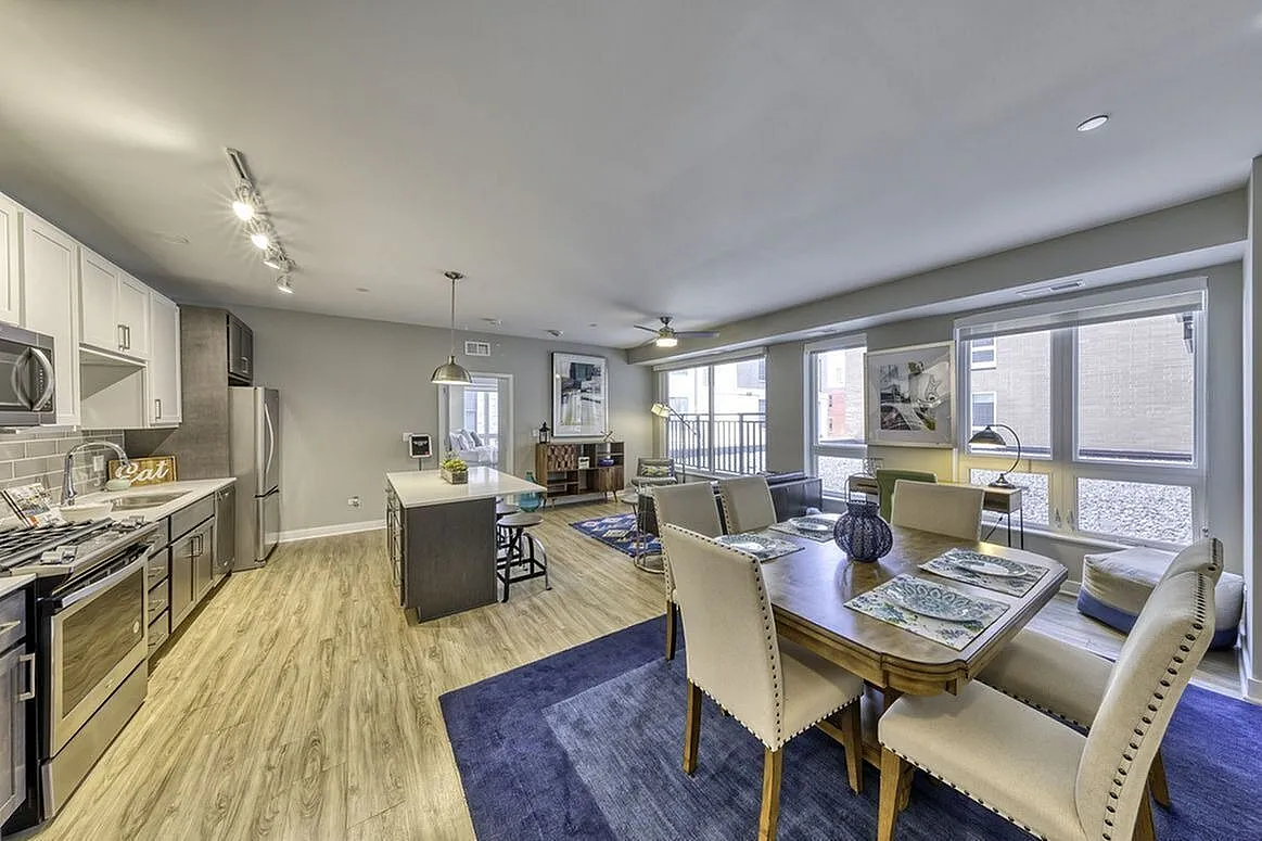 Modern open-concept kitchen and dining area with stylish stainless steel appliances, sleek cabinetry, and ample natural light.