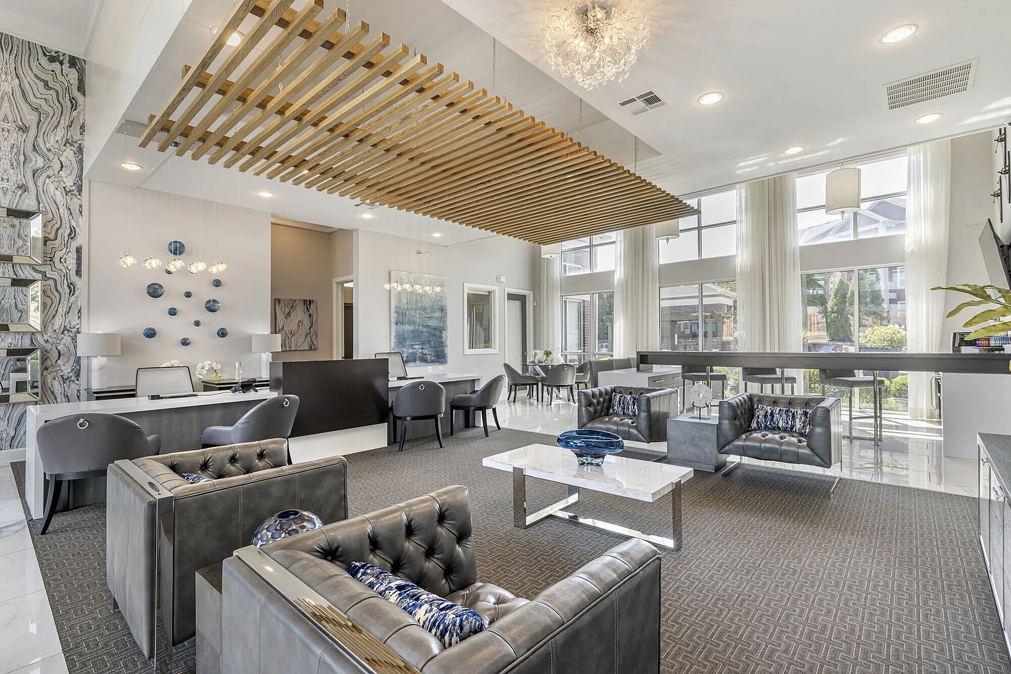 Elegant and contemporary lobby featuring luxurious seating, modern decor accents, and expansive windows for natural light.