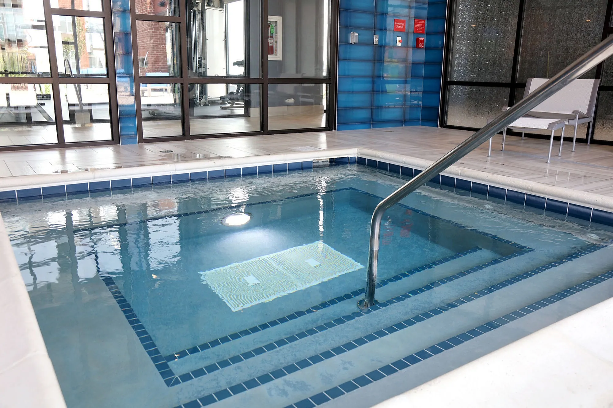 Luxurious indoor pool with sleek modern design and comfortable seating for relaxation