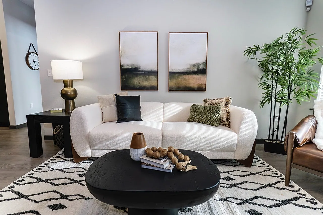 Cozy and modern living room with a stylish white sofa, chic art pieces, and elegant decor.