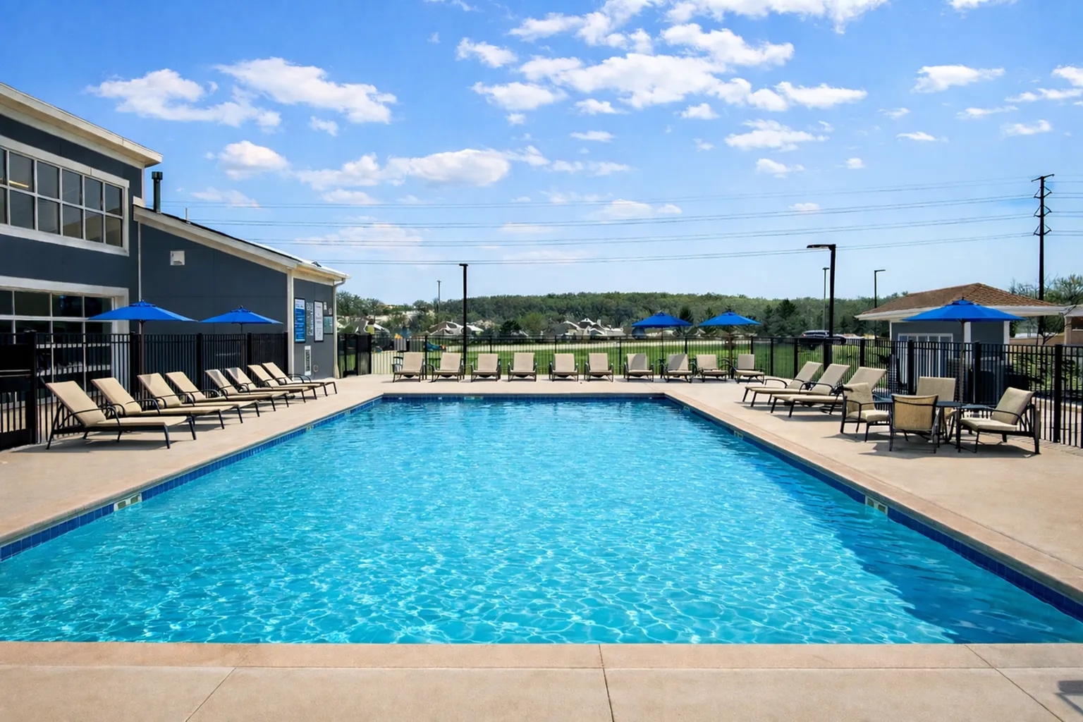 Inviting outdoor pool area with sun loungers and umbrellas, perfect for relaxation and leisure on a sunny day.