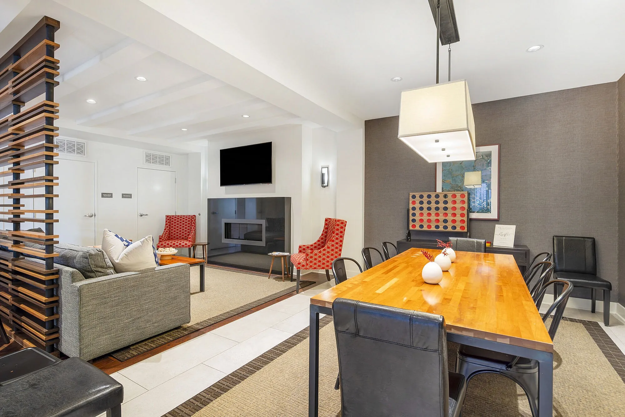 Inviting modern living area with stylish decor, featuring a cozy fireplace, chic dining table, and plush seating.