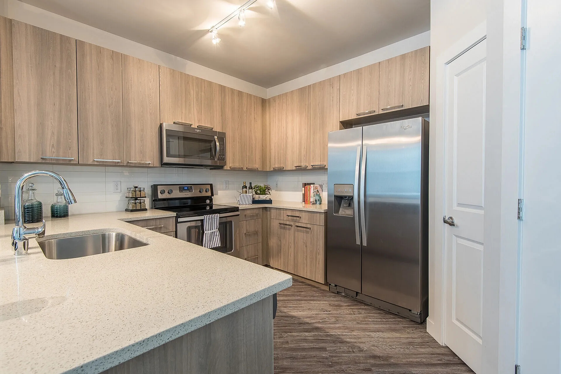 Modern kitchen with sleek stainless steel appliances, elegant wood cabinetry, and polished countertops, offering a sophisticated and functional cooking space.