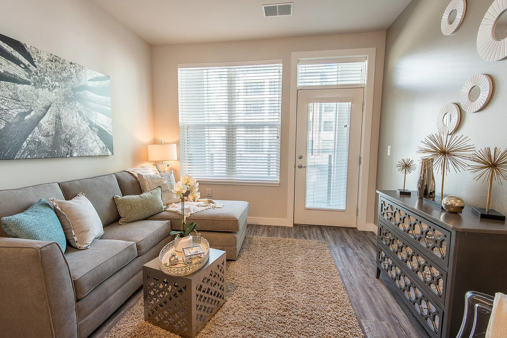 Inviting living room with stylish decor, large windows, and plush seating arrangement, perfect for relaxation and entertaining.