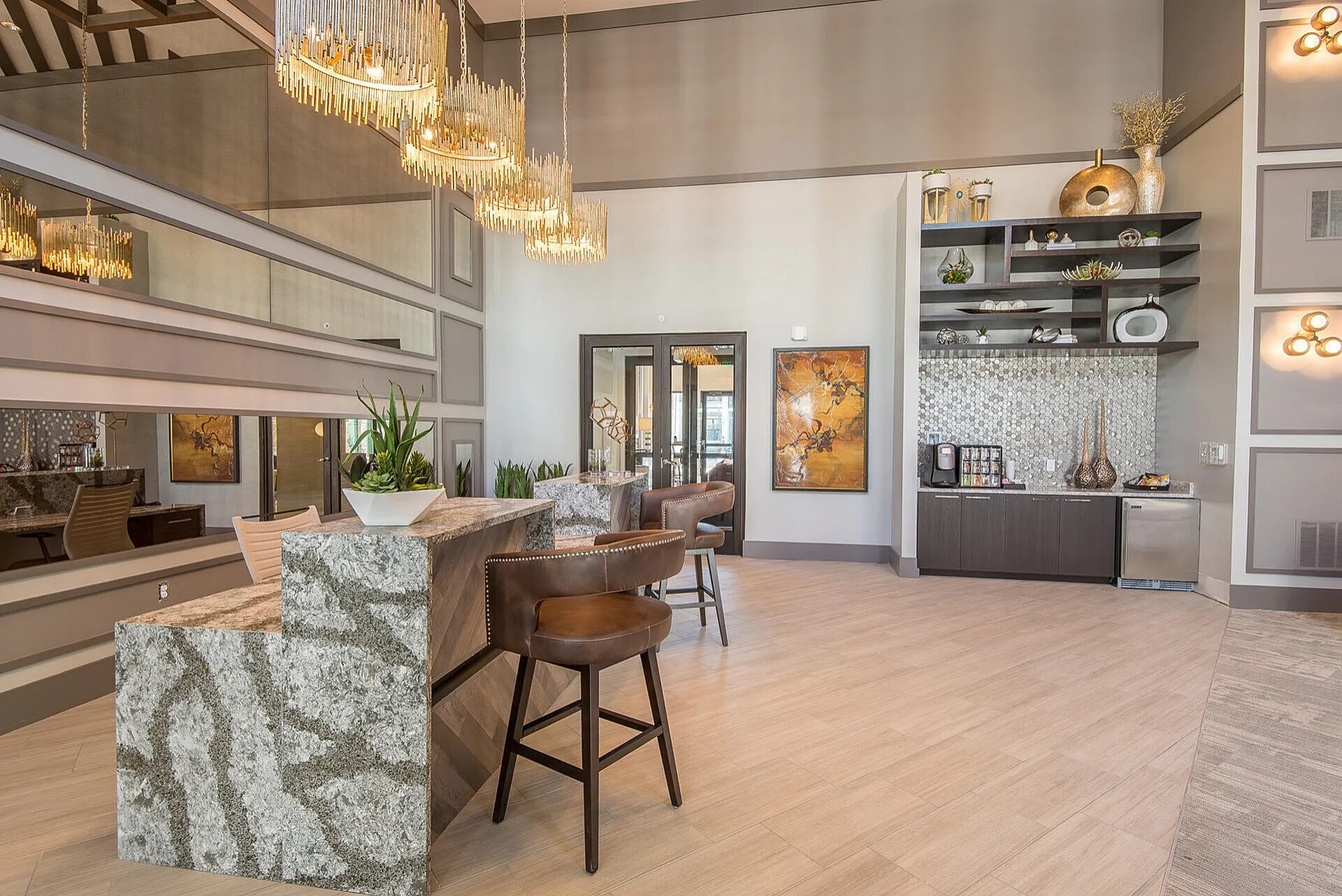 Chic apartment interior showcasing elegant lighting, modern decor, and a stylish counter with seating, creating a welcoming atmosphere.