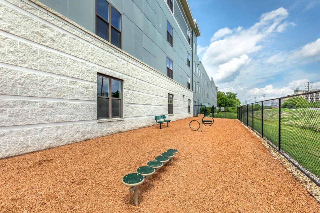 Charming outdoor space with a modern building exterior, inviting seating, and play area perfect for relaxation and enjoyment.