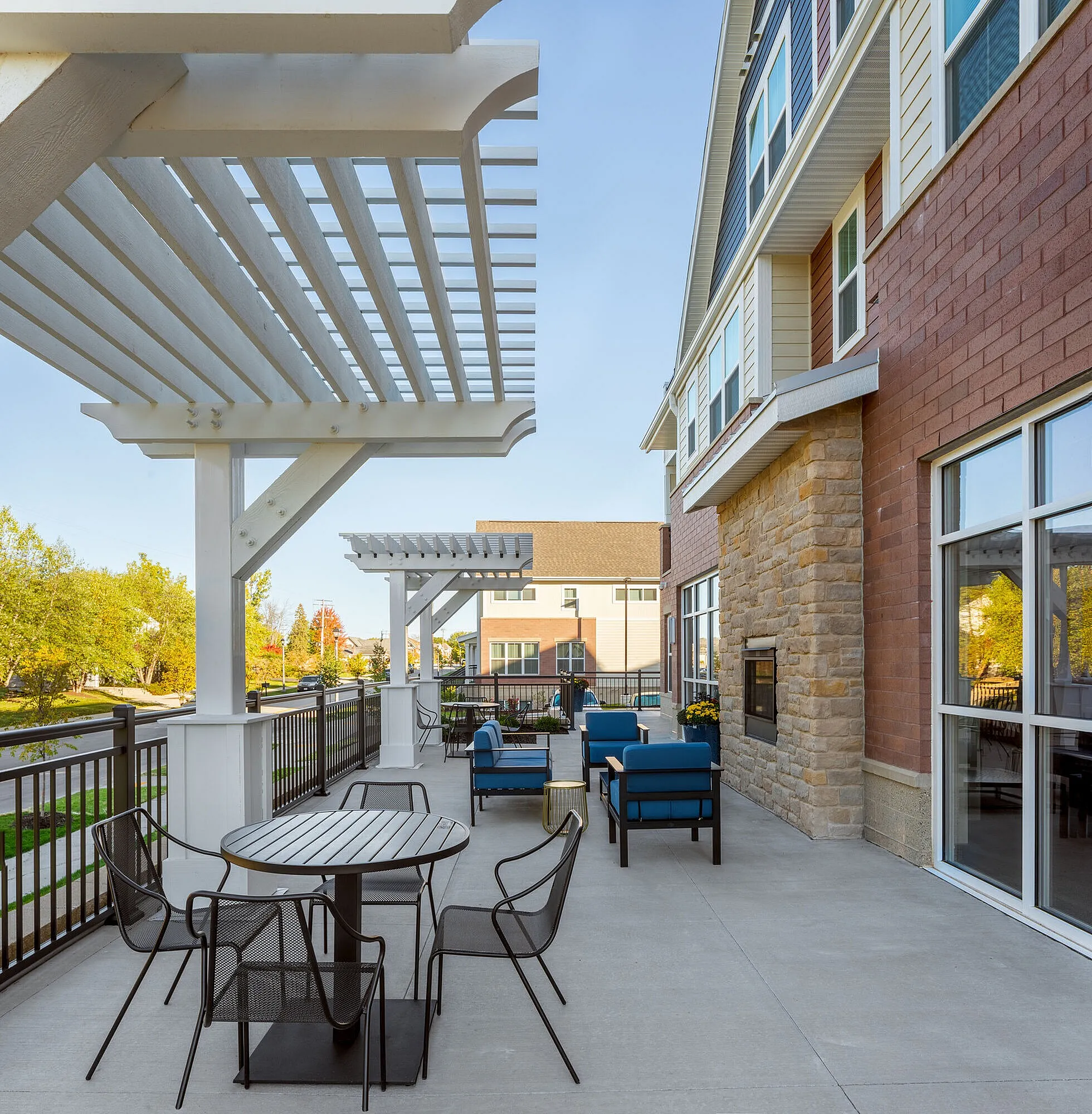 Charming outdoor patio with modern seating, elegant pergolas, and vibrant greenery offering a perfect relaxation spot.
