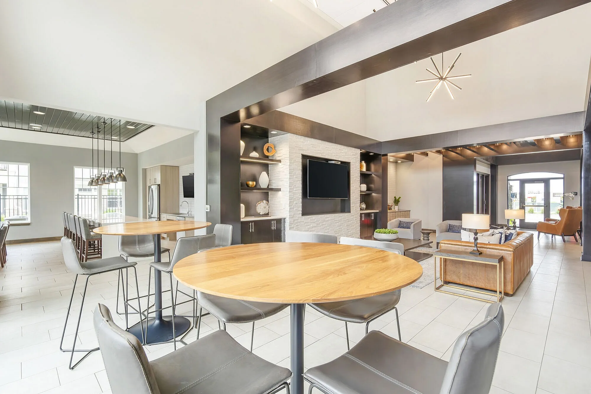 Modern open-concept living space with elegant seating, stylish dining area, and large windows for natural light.