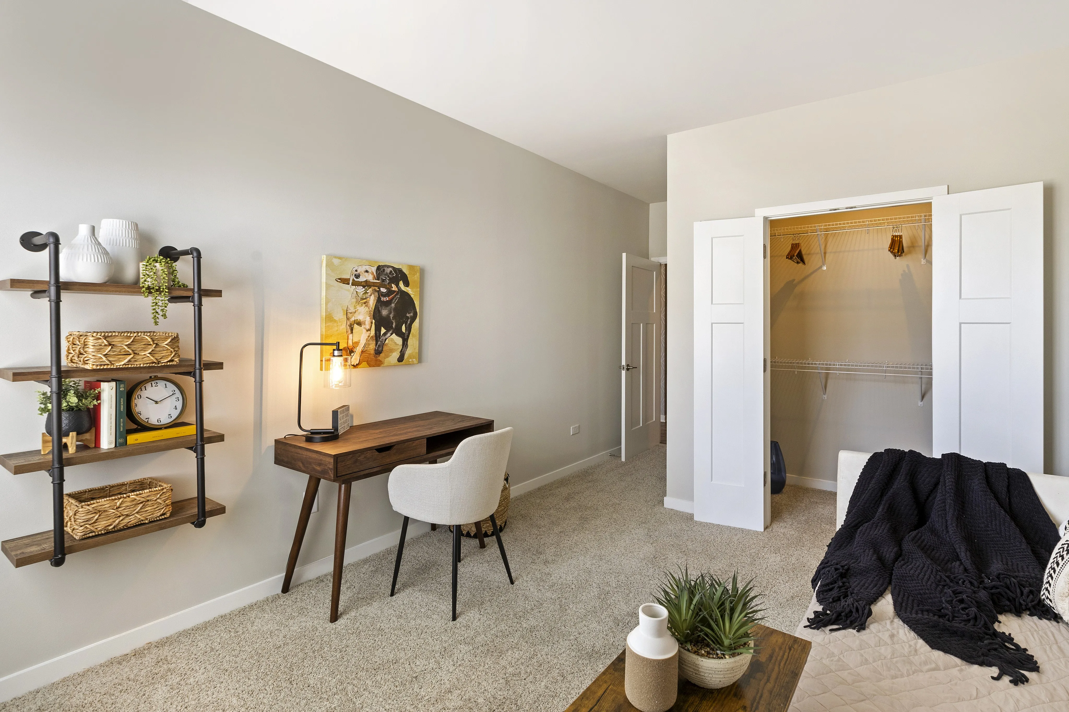 Charming home office space with modern wooden desk, cozy chair, and decorative shelving, perfect for inspiring productivity.