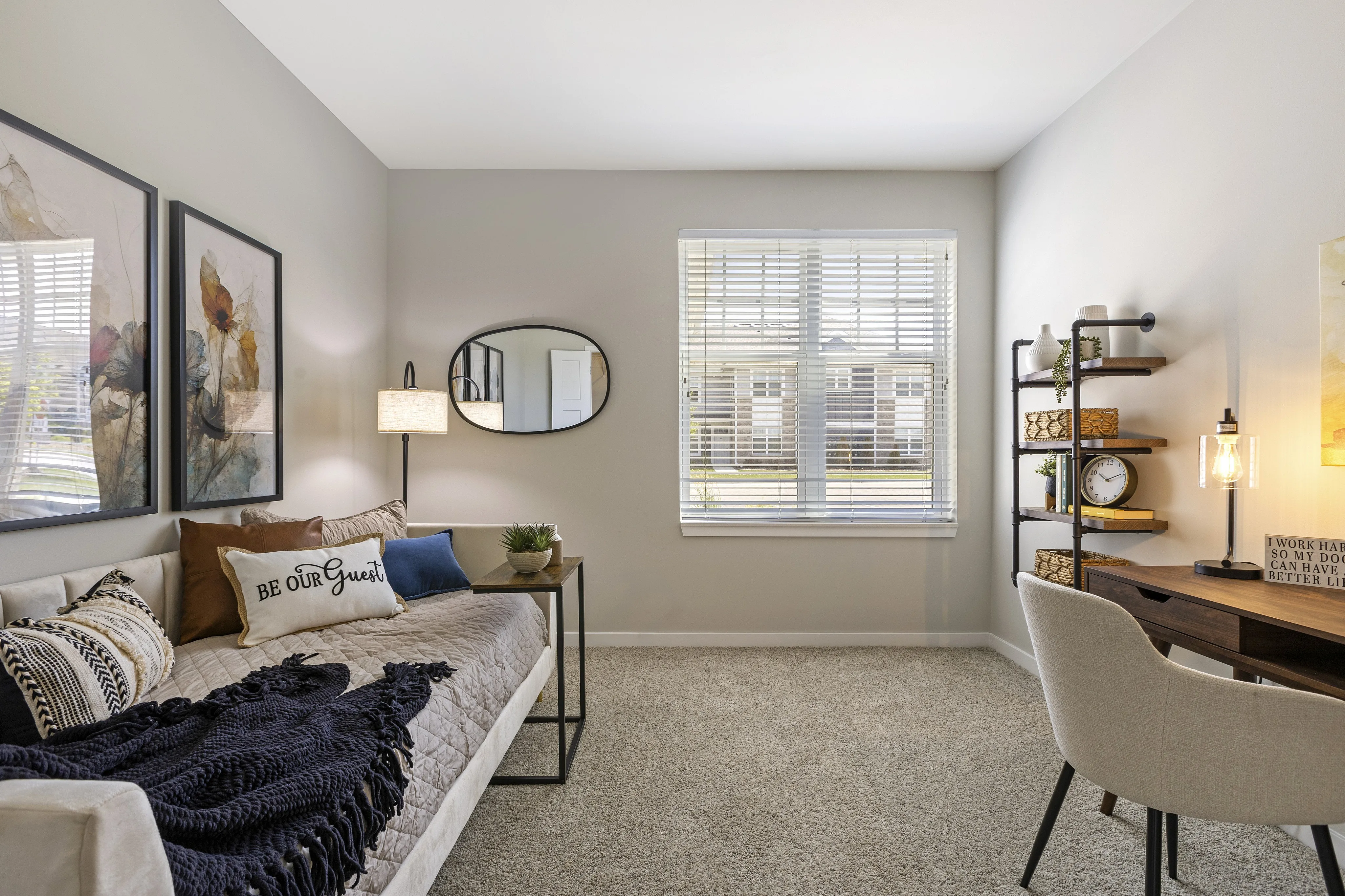 Bright and inviting home office with a cozy daybed, elegant decor, and a spacious desk, ideal for a productive and serene workspace.