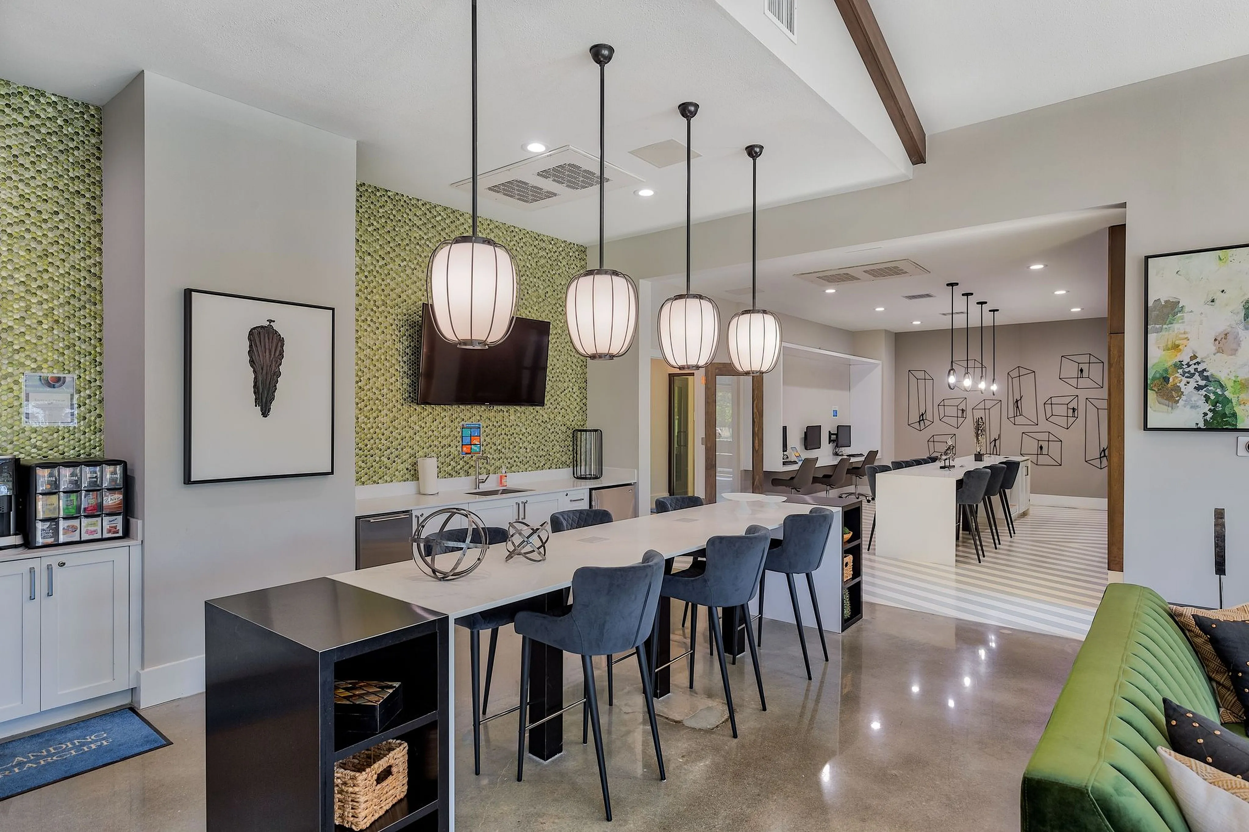 Modern community lounge with chic pendant lighting, sleek bar seating, and vibrant decor offering a stylish social space.