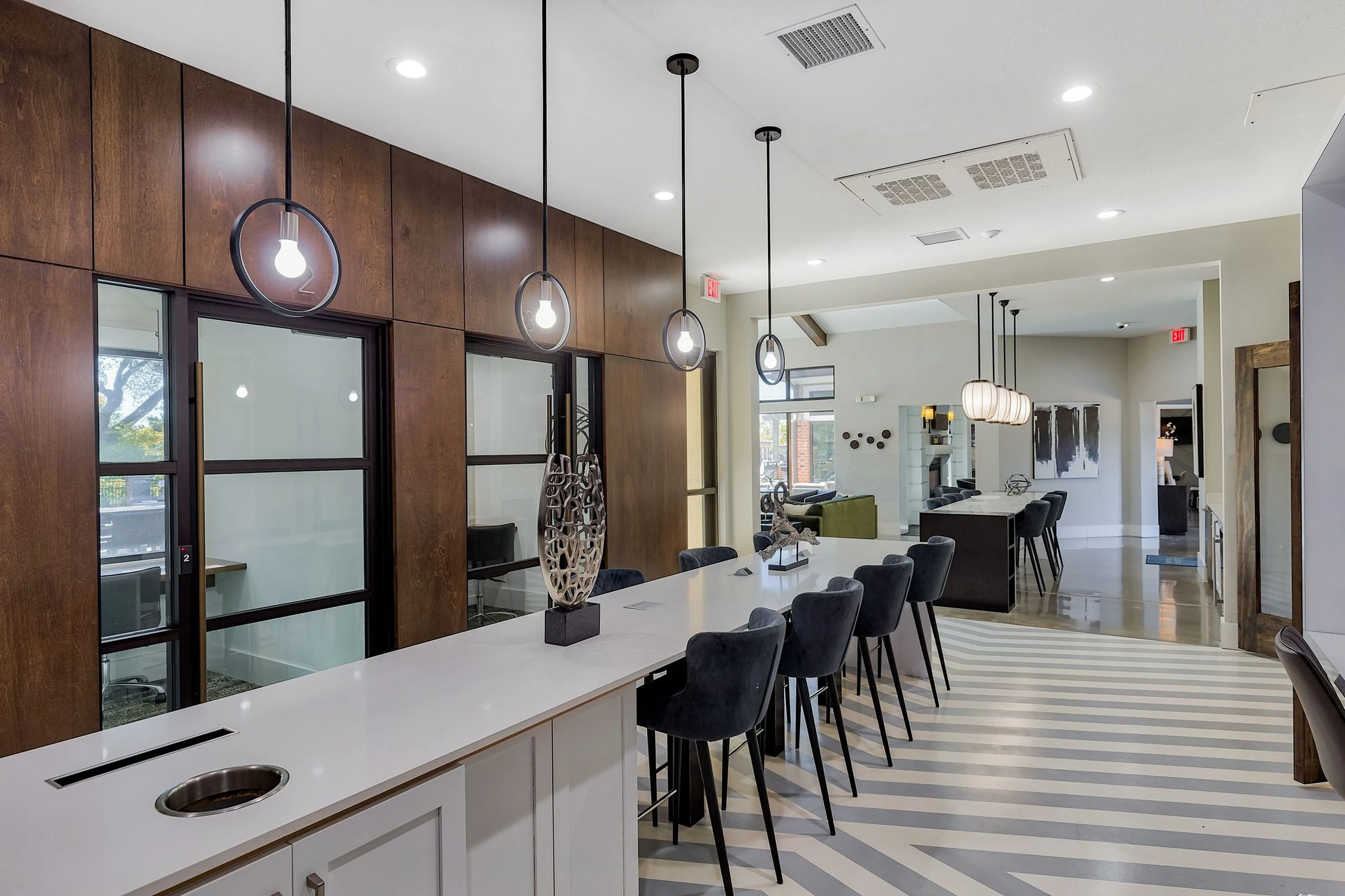 Chic modern communal space with elegant lighting, stylish seating, and a sophisticated design.