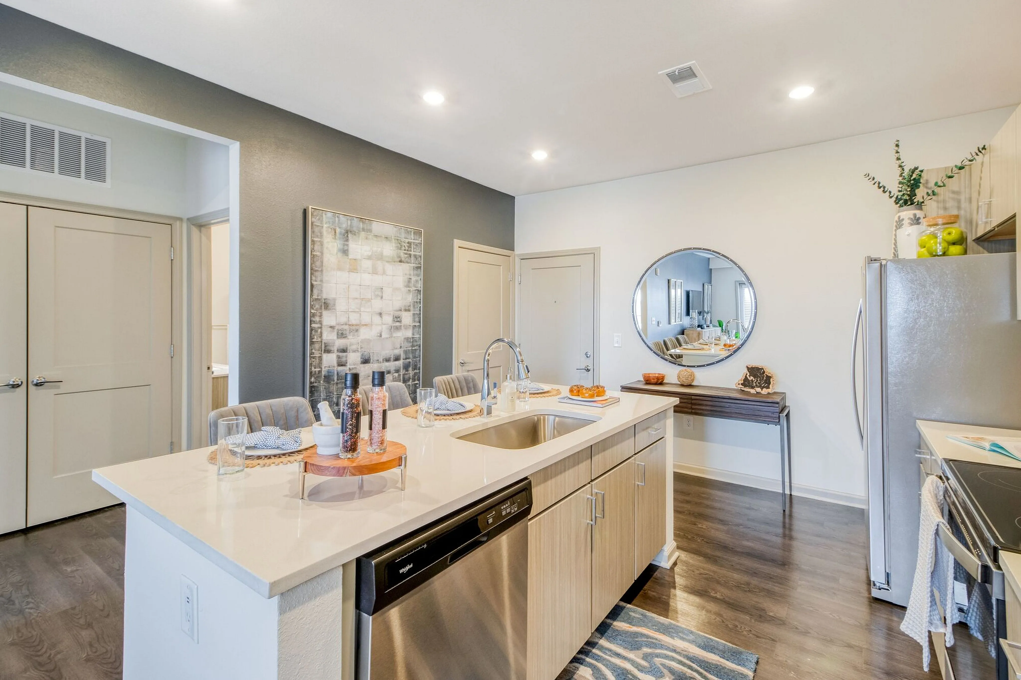 Contemporary kitchen featuring elegant countertops, stainless steel appliances, and a cozy dining area, perfect for modern living.