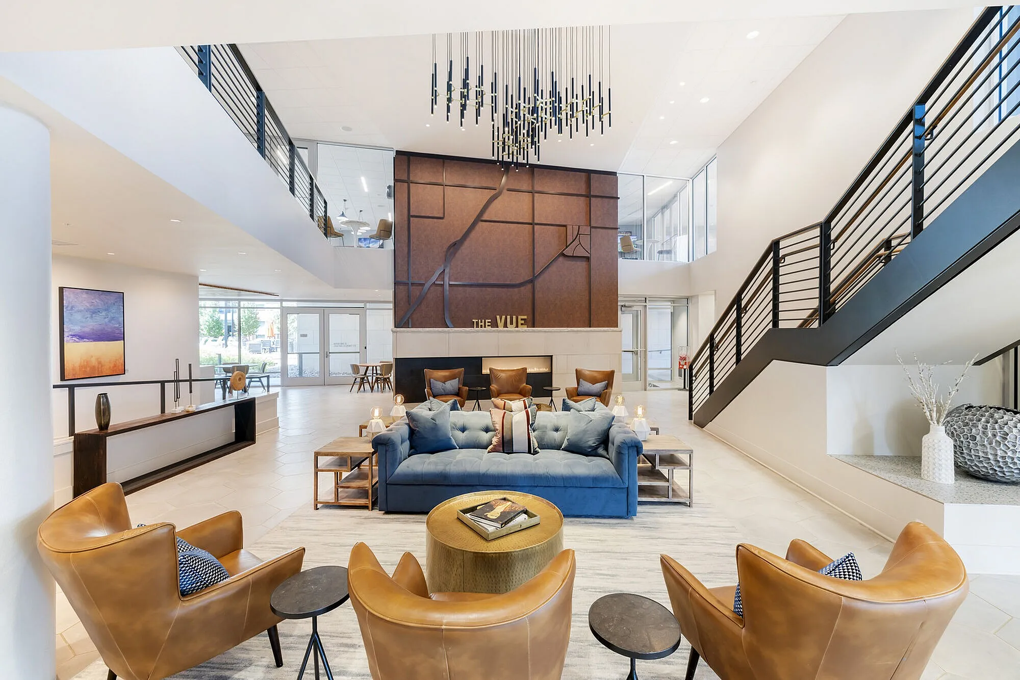 Luxurious apartment lobby with modern decor, featuring a stylish seating area, elegant lighting, and spacious open design at The Vue.