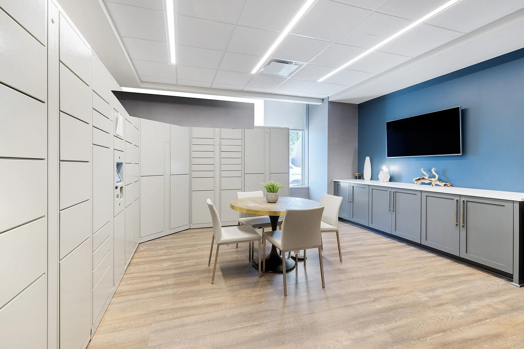 Contemporary and stylish lounge area with a round table, elegant seating, and sleek storage solutions.