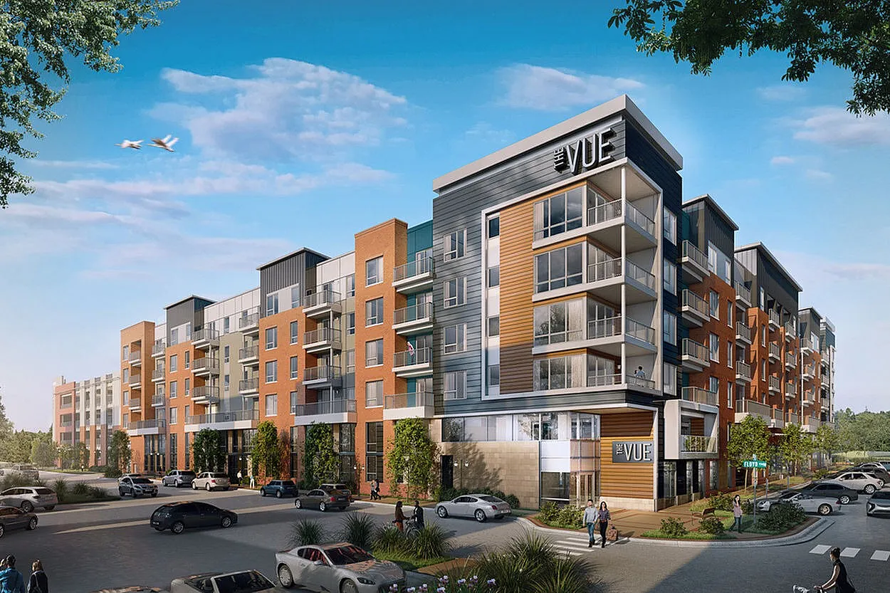 Modern apartment complex showcasing sleek architecture with spacious balconies and lush landscaping, set under a clear blue sky.