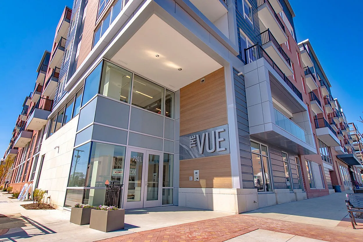 Modern apartment complex exterior with sleek design and large windows at The VUE.