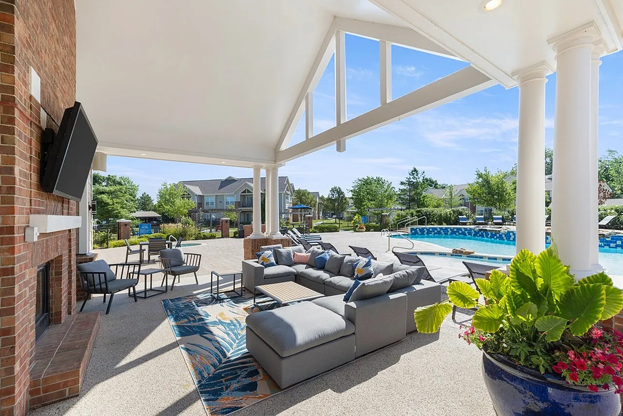 Luxurious outdoor lounge area with modern seating and pool view, ideal for relaxation and entertaining.