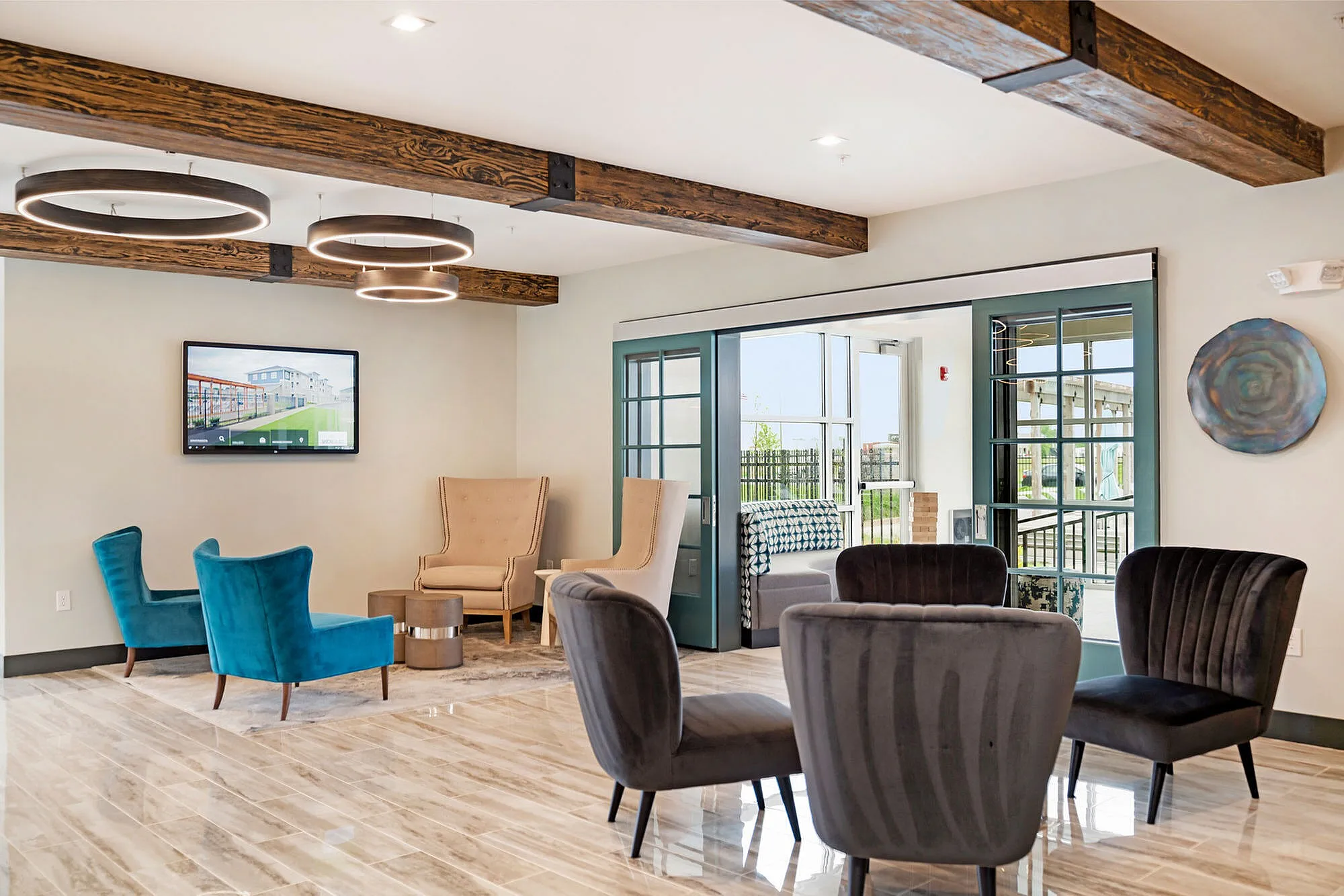 Inviting modern lounge with stylish seating, chic circular lighting, and sophisticated decor.