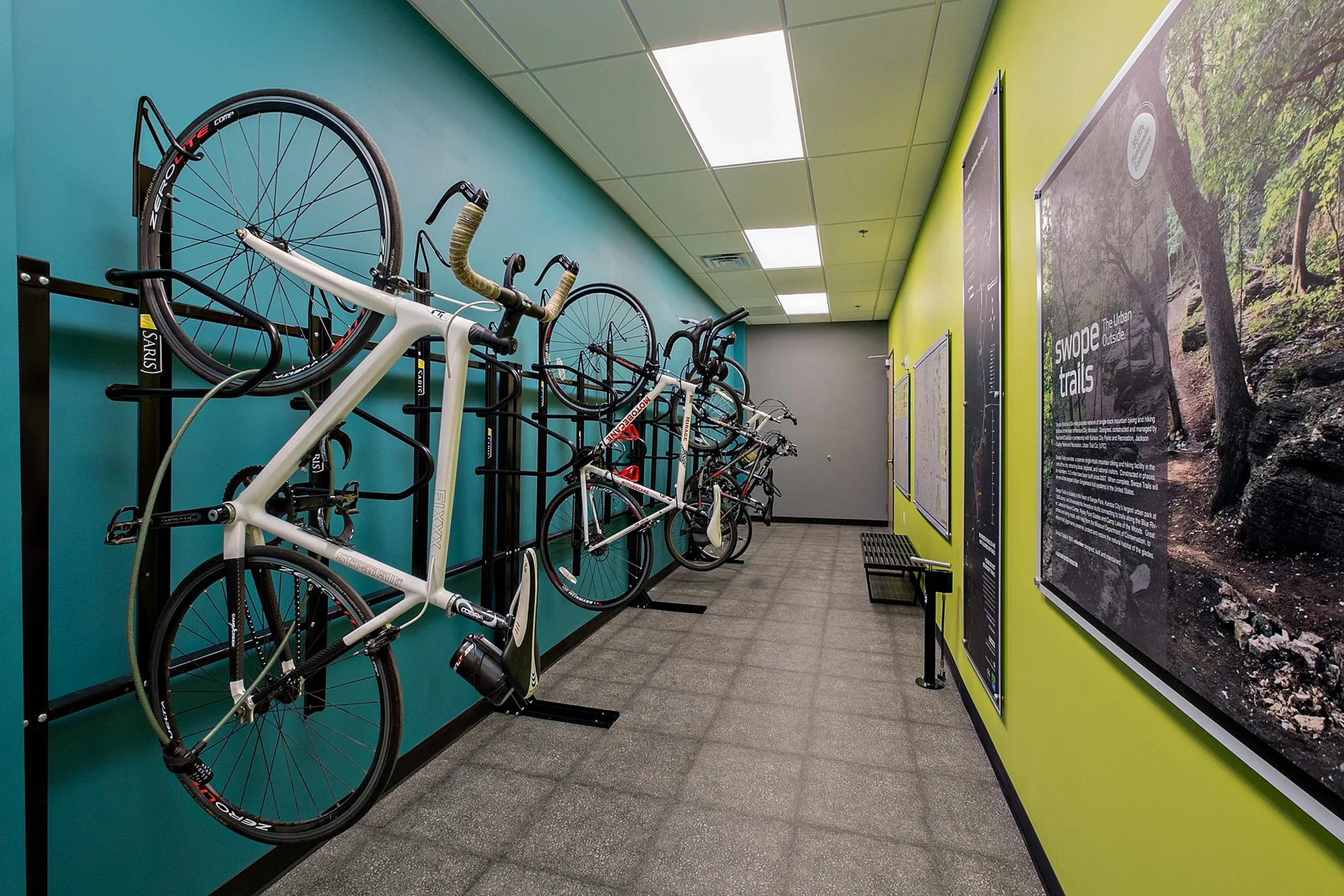 Modern bike storage room featuring multiple bicycles on wall-mounted racks, vibrant colored walls, and a sleek design perfect for urban living.