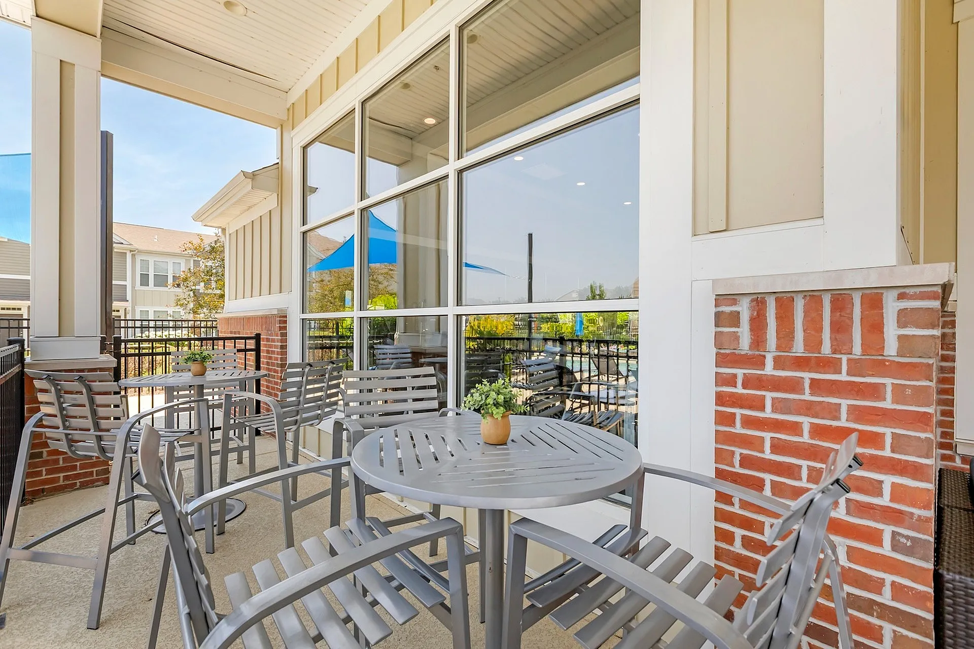 Charming outdoor patio with elegant metal chairs and a small table, perfect for enjoying sunny afternoons.