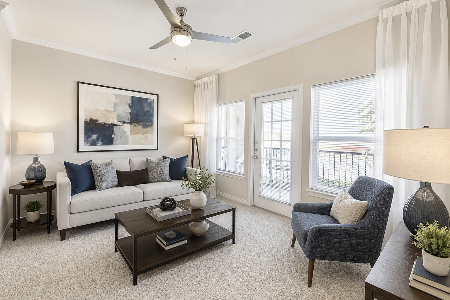 Bright and modern living room with elegant decor, featuring a cozy sofa, chic armchair, and vibrant artwork, complemented by large windows and natural light.