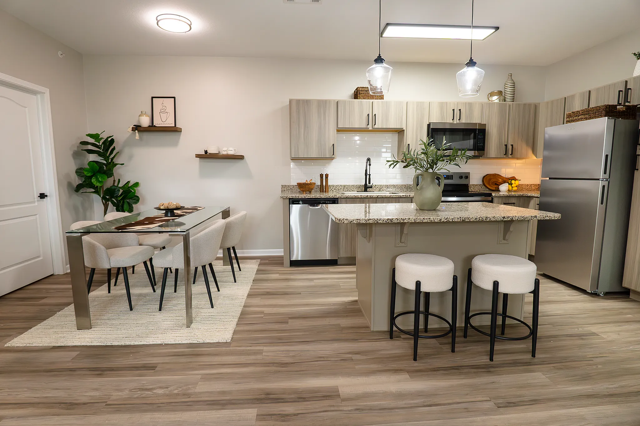Open kitchen and dining area in a newly renovated apartment at Enclave at 127th in Plainfield.