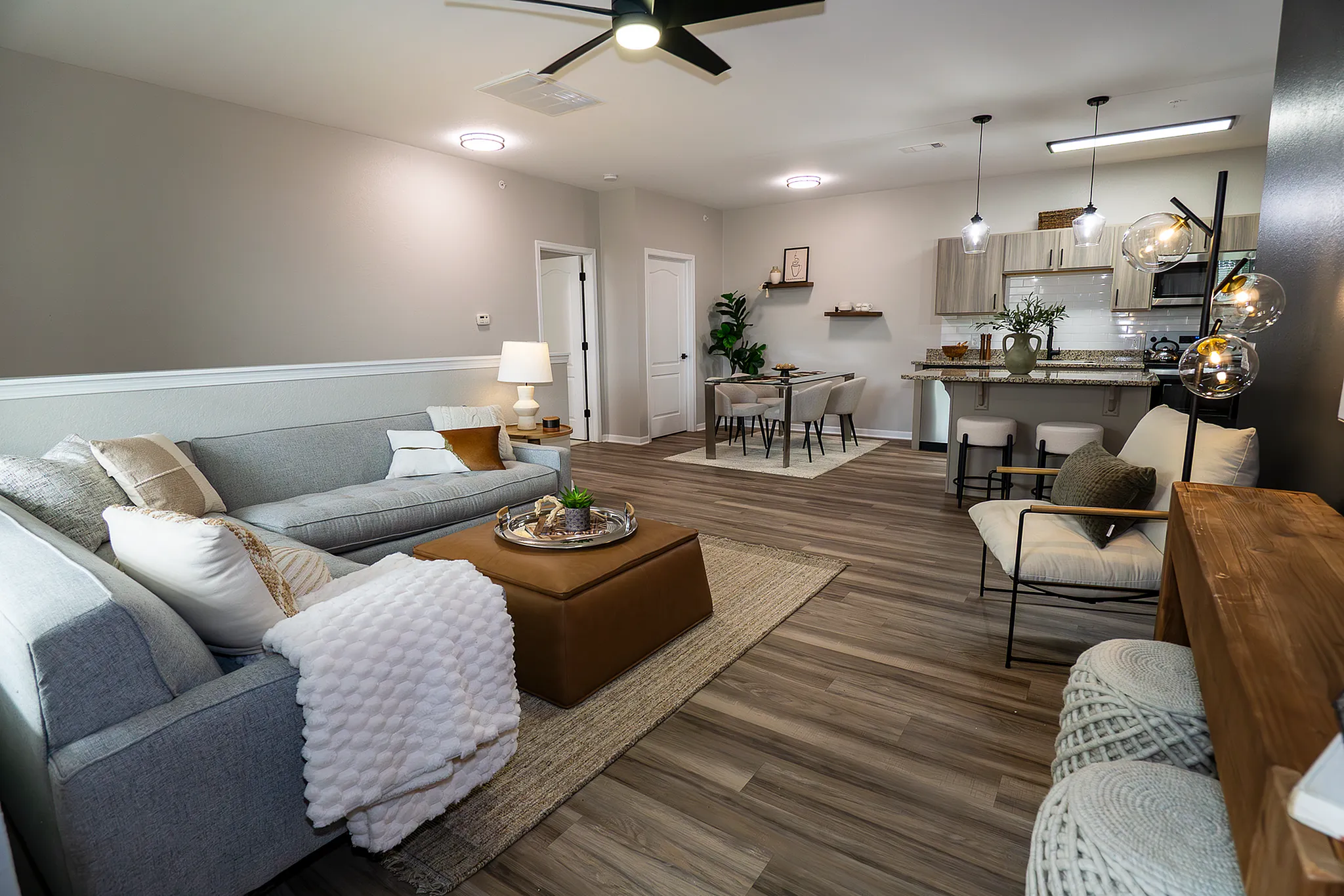 Open-concept living, dining and kitchen area in a renovated Enclave at 127th apartment