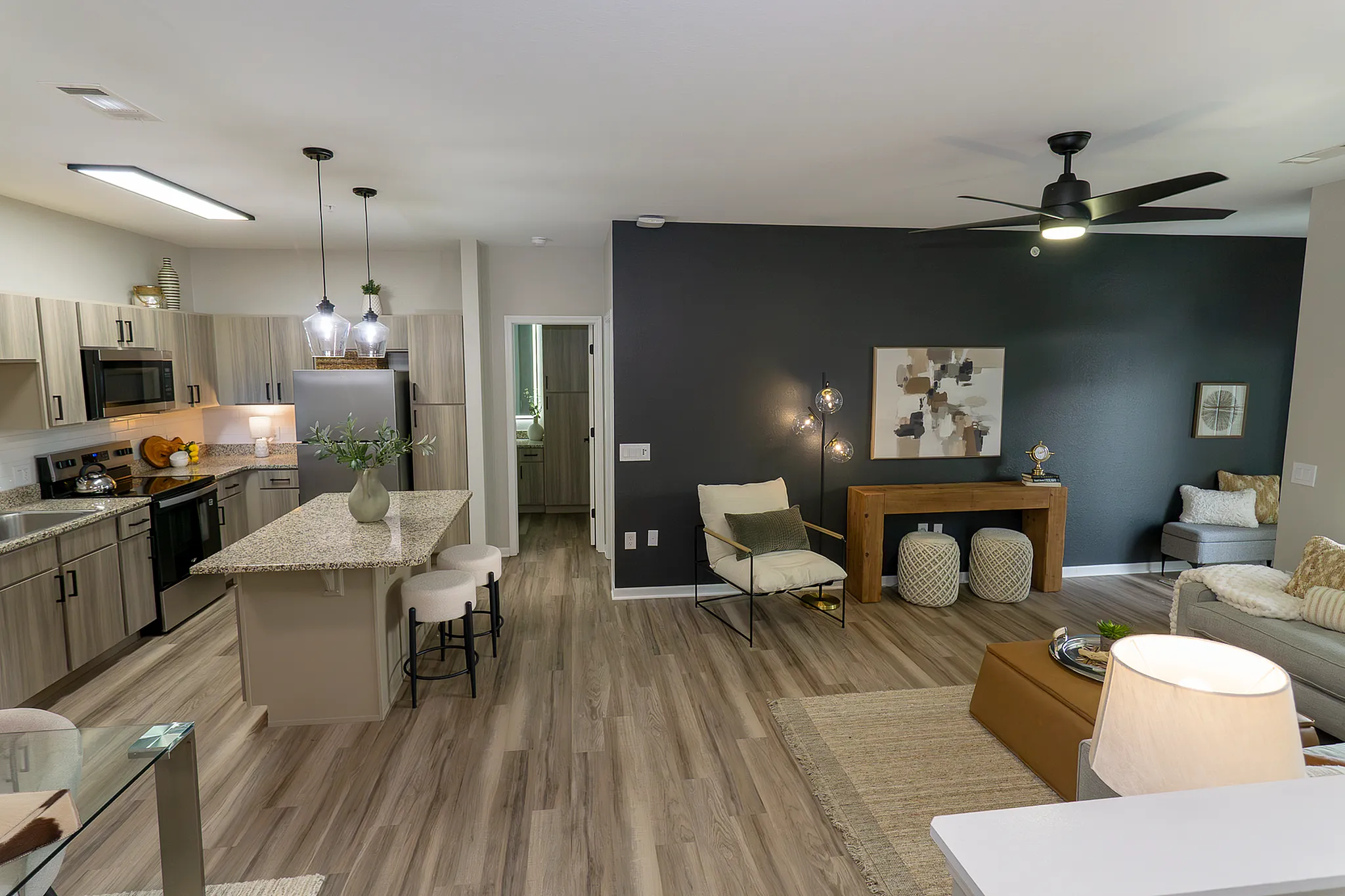 Newly renovated open-concept apartment home with spacious living room and kitchen.