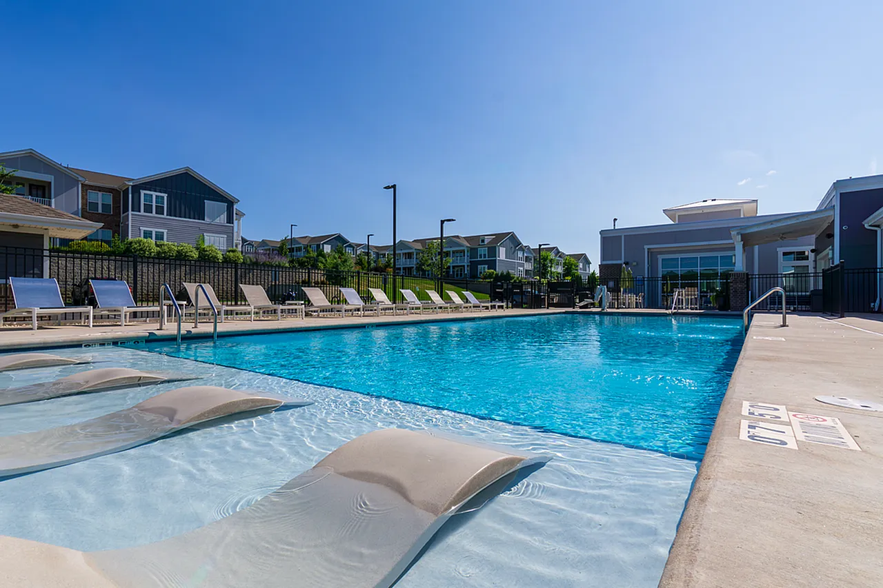 Inviting outdoor pool area with sun loungers and umbrellas, perfect for relaxation and leisure on a sunny day.