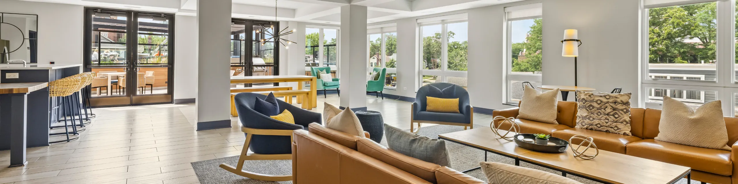 Contemporary open-concept living space featuring chic seating, abundant natural light, and stylish decor with outdoor views.