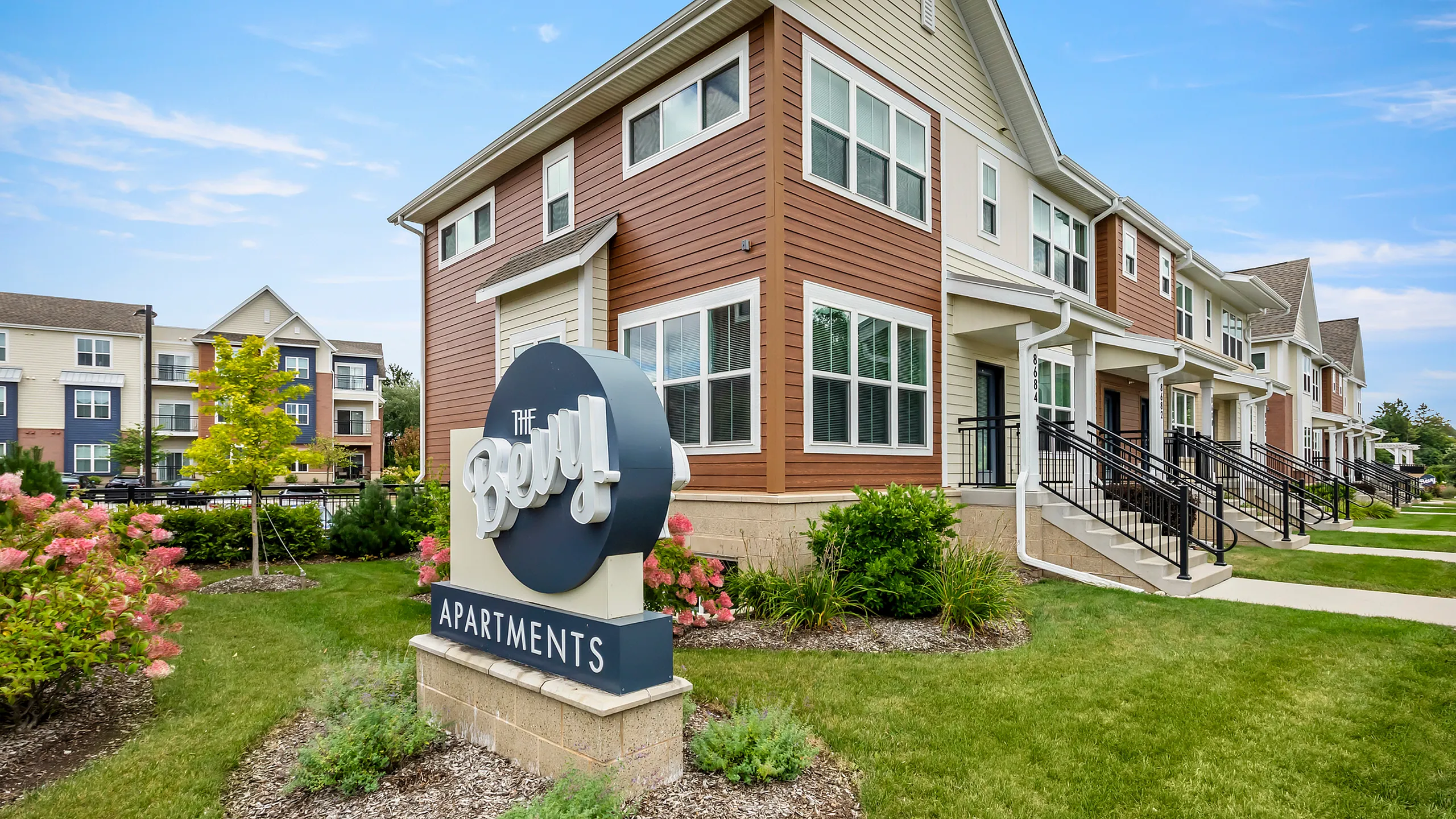 Charming modern apartments with lush landscaping and inviting architecture at The Beryl Apartments.