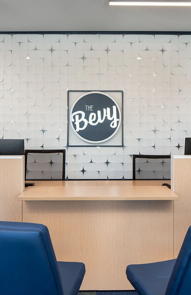 Modern reception area of The Bevy featuring elegant wall design and contemporary furnishings.