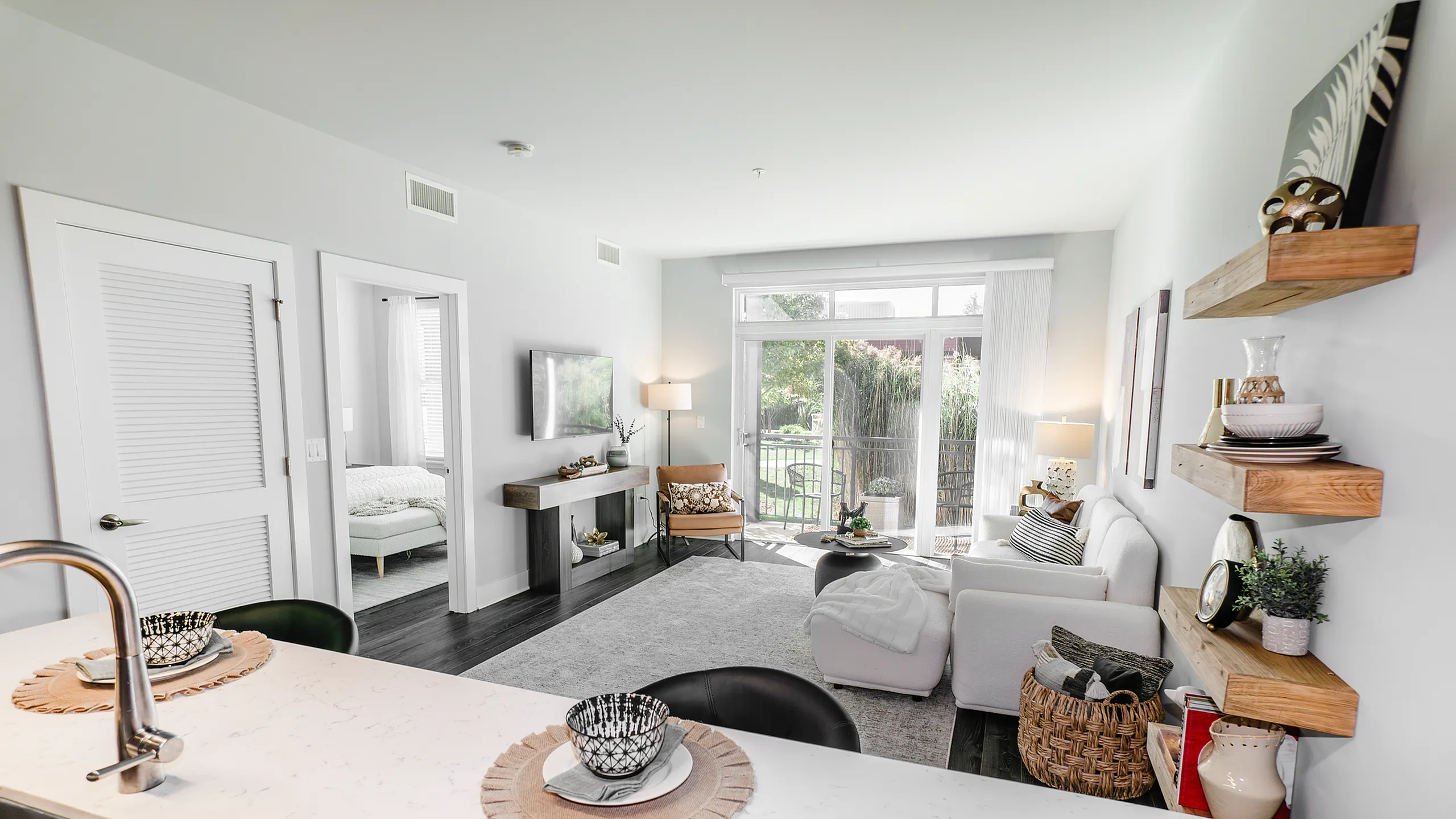 Elegant open-concept living room with garden views, contemporary decor, and abundant natural light.