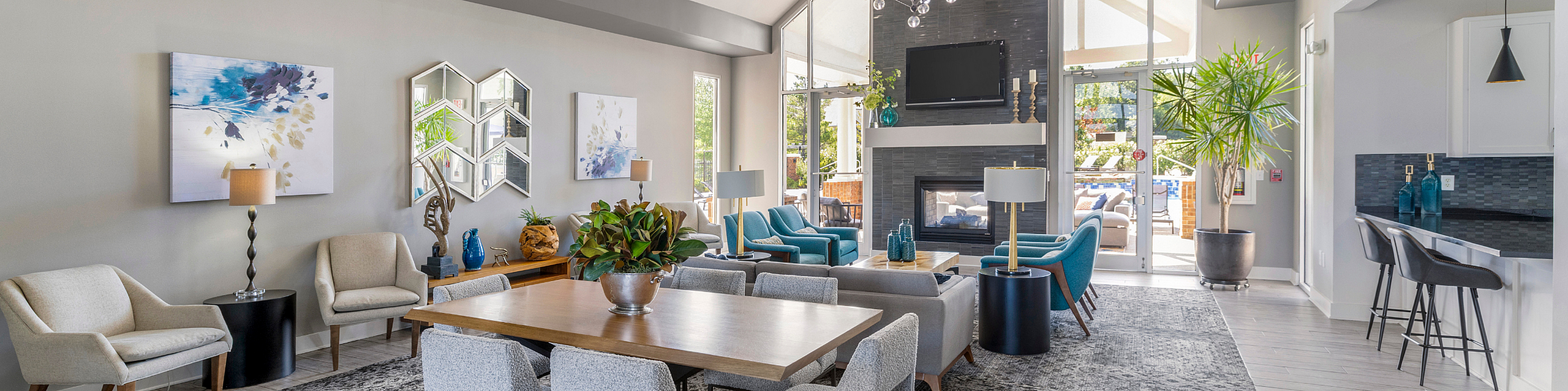 Modern and inviting living area with stylish decor, featuring a cozy fireplace, elegant dining setup, and plenty of natural light.