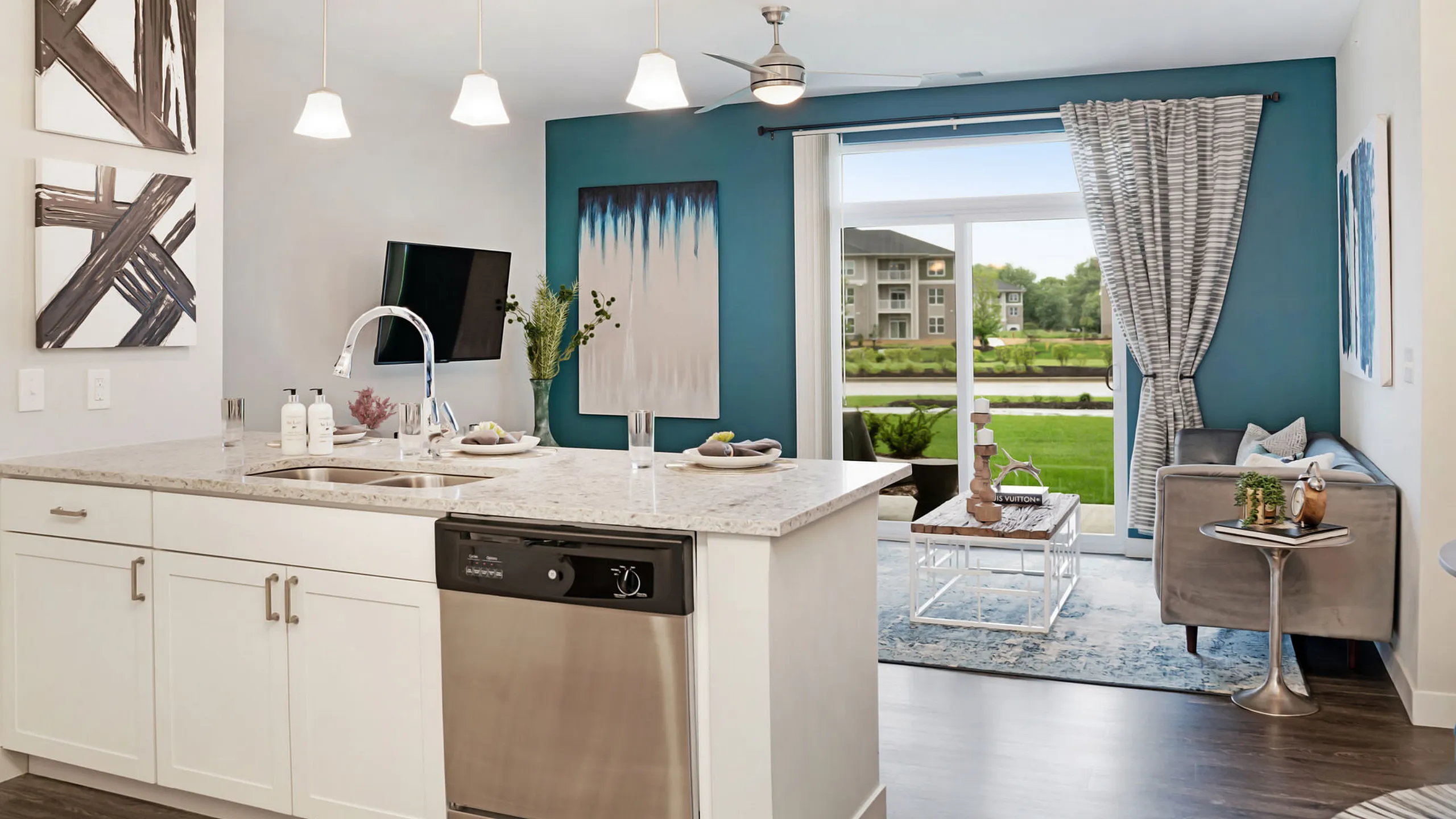 Modern apartment interior showcasing a stylish kitchen island, cozy living space with vibrant decor, and large windows offering scenic views.