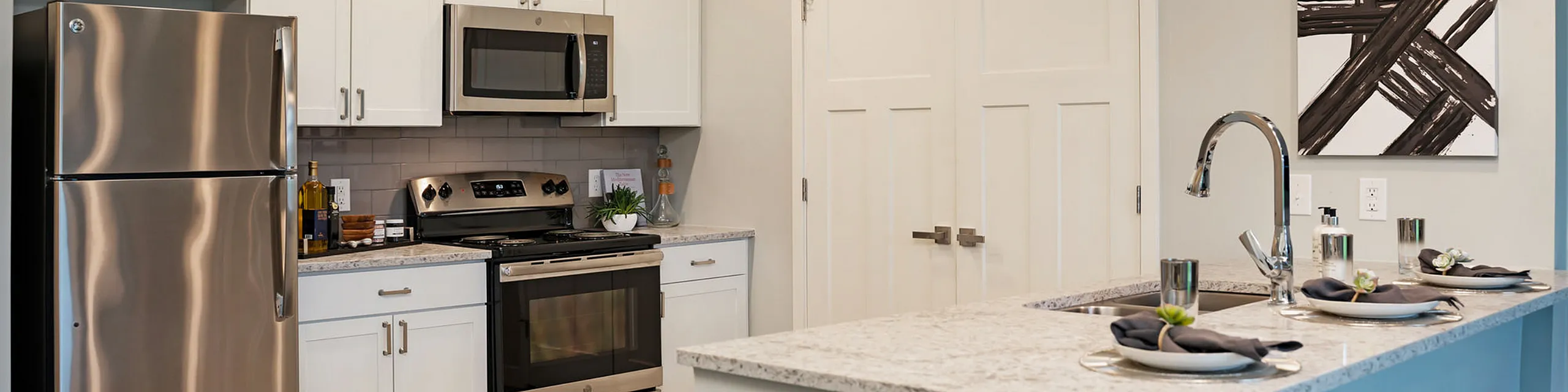 Modern kitchen with stainless steel appliances, granite countertops, and stylish decor providing a sleek and inviting cooking space.