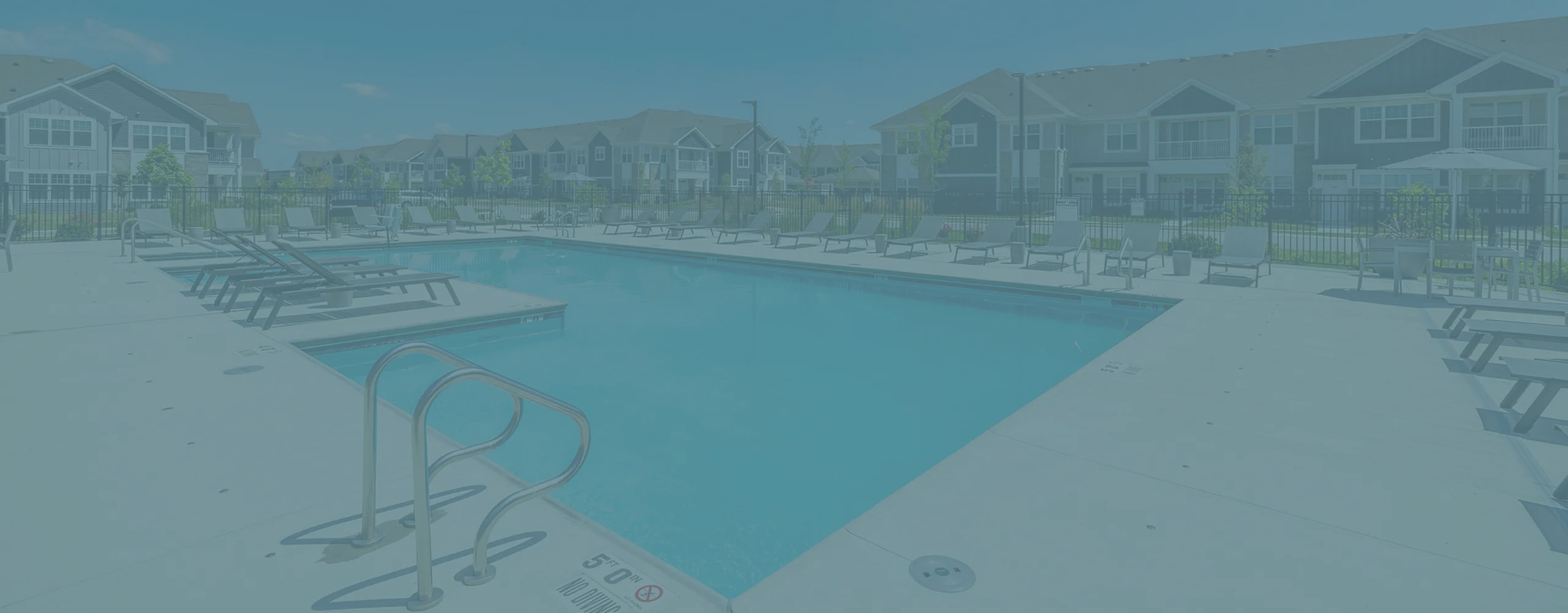 Inviting communal swimming pool surrounded by modern apartment buildings, perfect for relaxation and social gatherings.